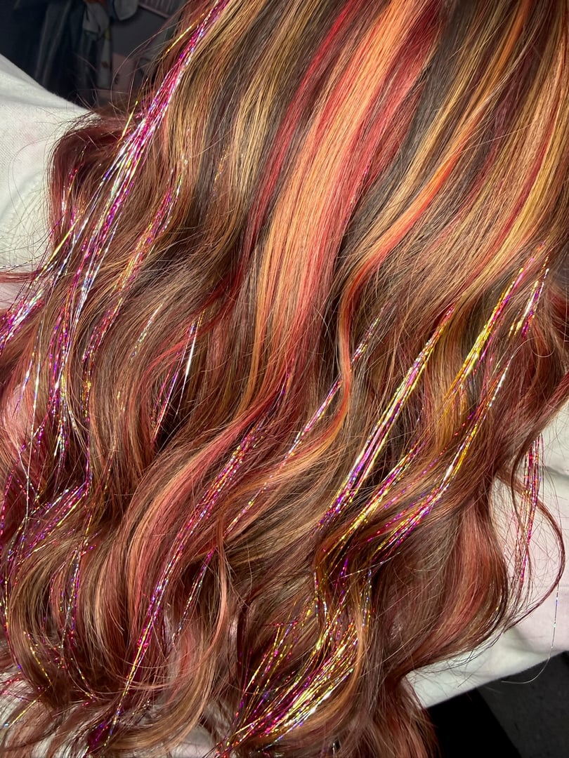 Copper auburn balayage hair color with dimensional red tones at best hair salon in Bradenton FL