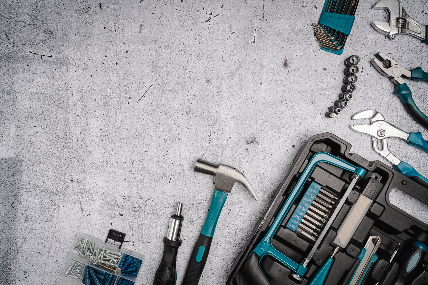 Assorted Hand Tools Laid Out on concrete background, top view with space for text