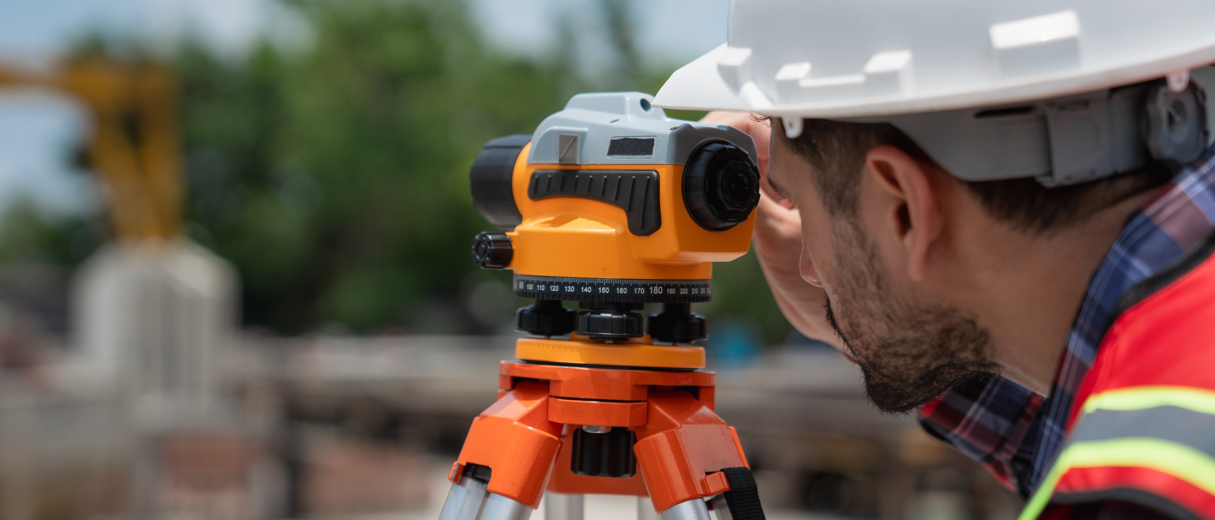 Civil or construction engineer using a survey camera, or an engineer with an auto level camera.