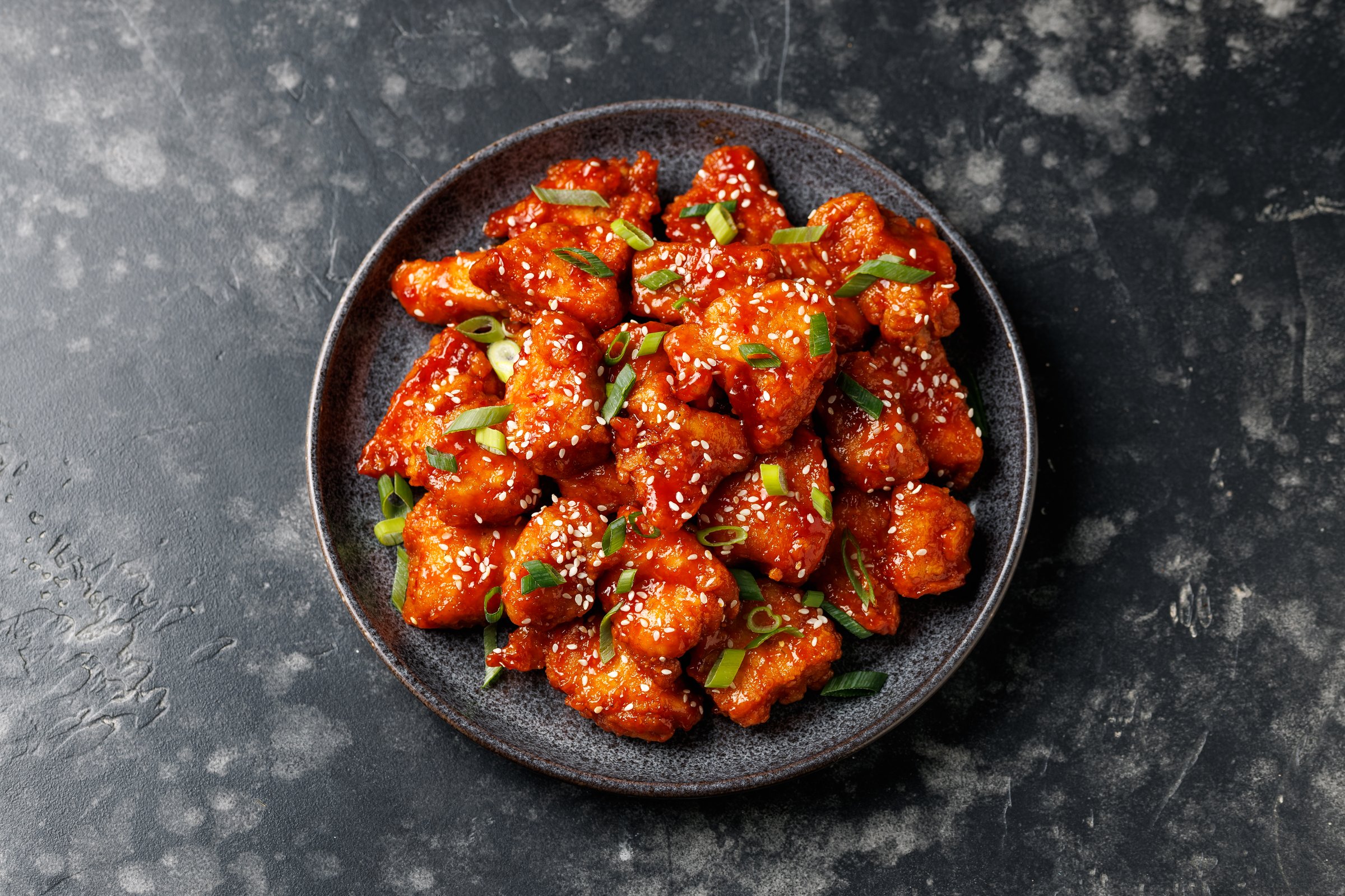 Crispy Sesame Chicken with a sticky asian sauce.