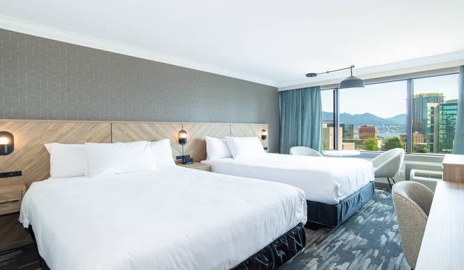 Hotel room with two queen beds showing modern renovated accommodation