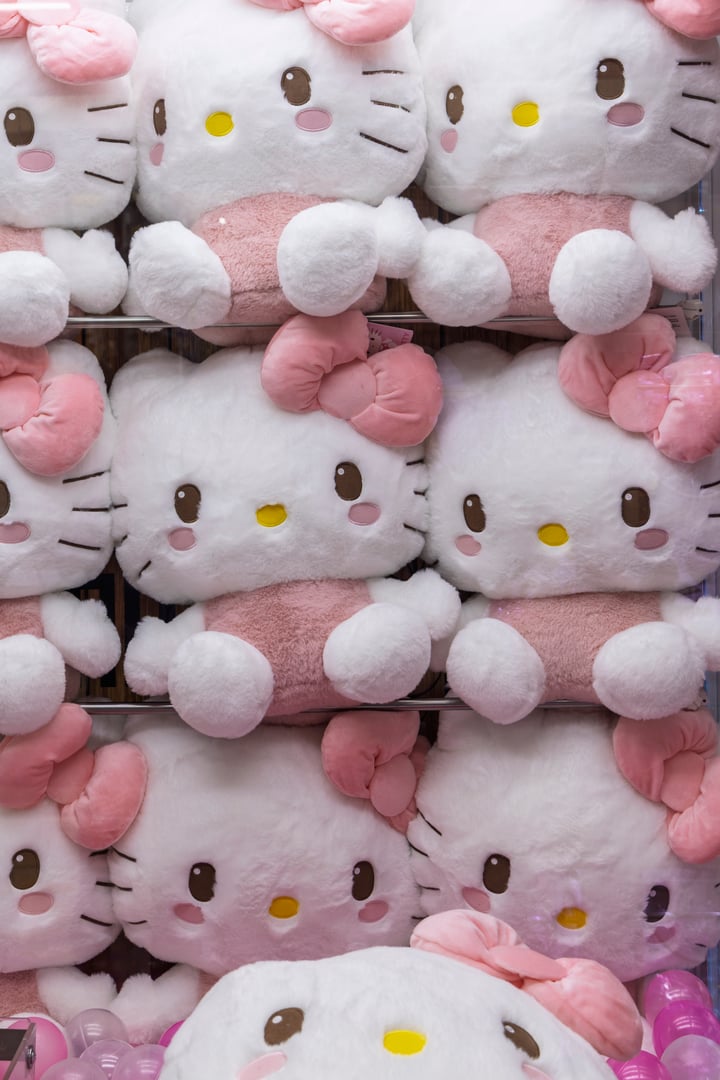 Osaka, Japan - March 30, 2025: Closeup of plush dolls Hello Kitty in vending machine in Osaka, Japan