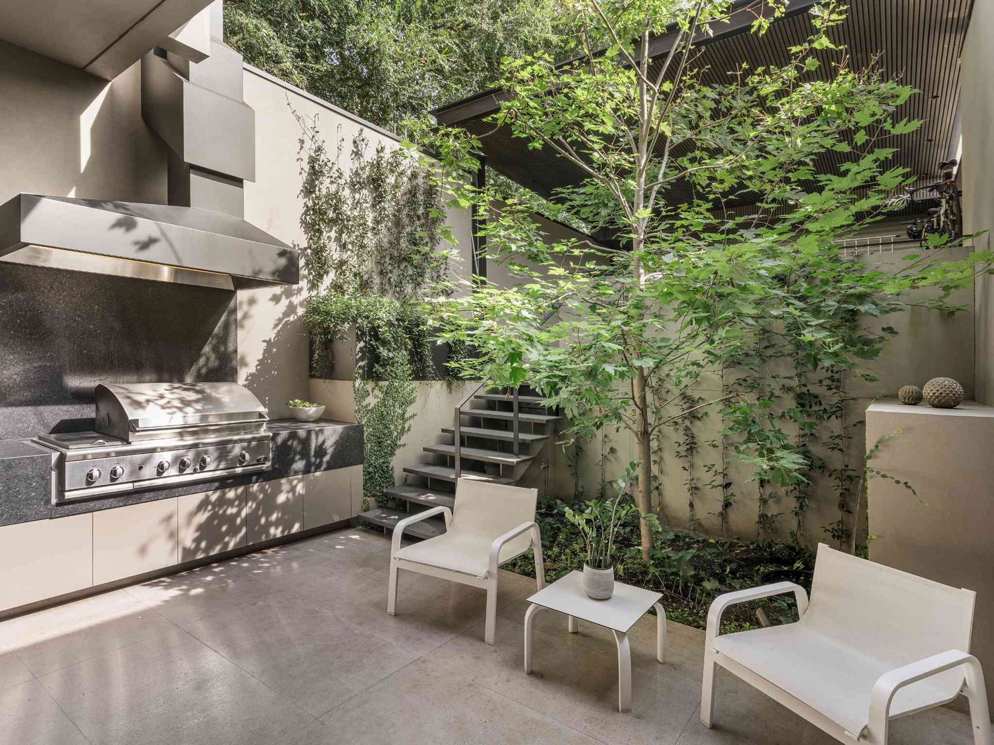 Contemporary kitchen with sleek stone island bench and integrated lighting by Individual Design
