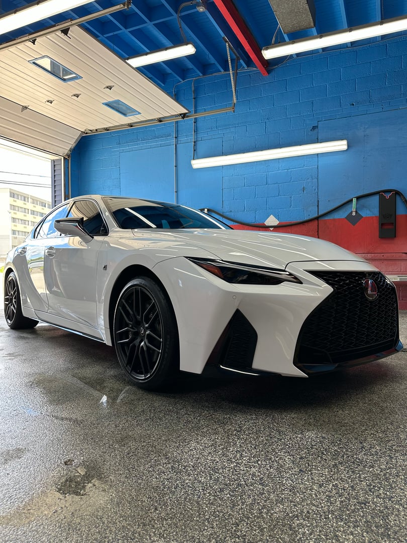 Red sports car rear view with perfect paint correction and high-gloss finish