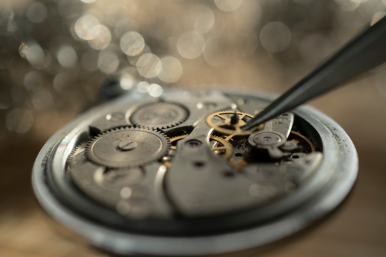 Pocket watch being repaired by senior watch maker, close-up. Black and white.