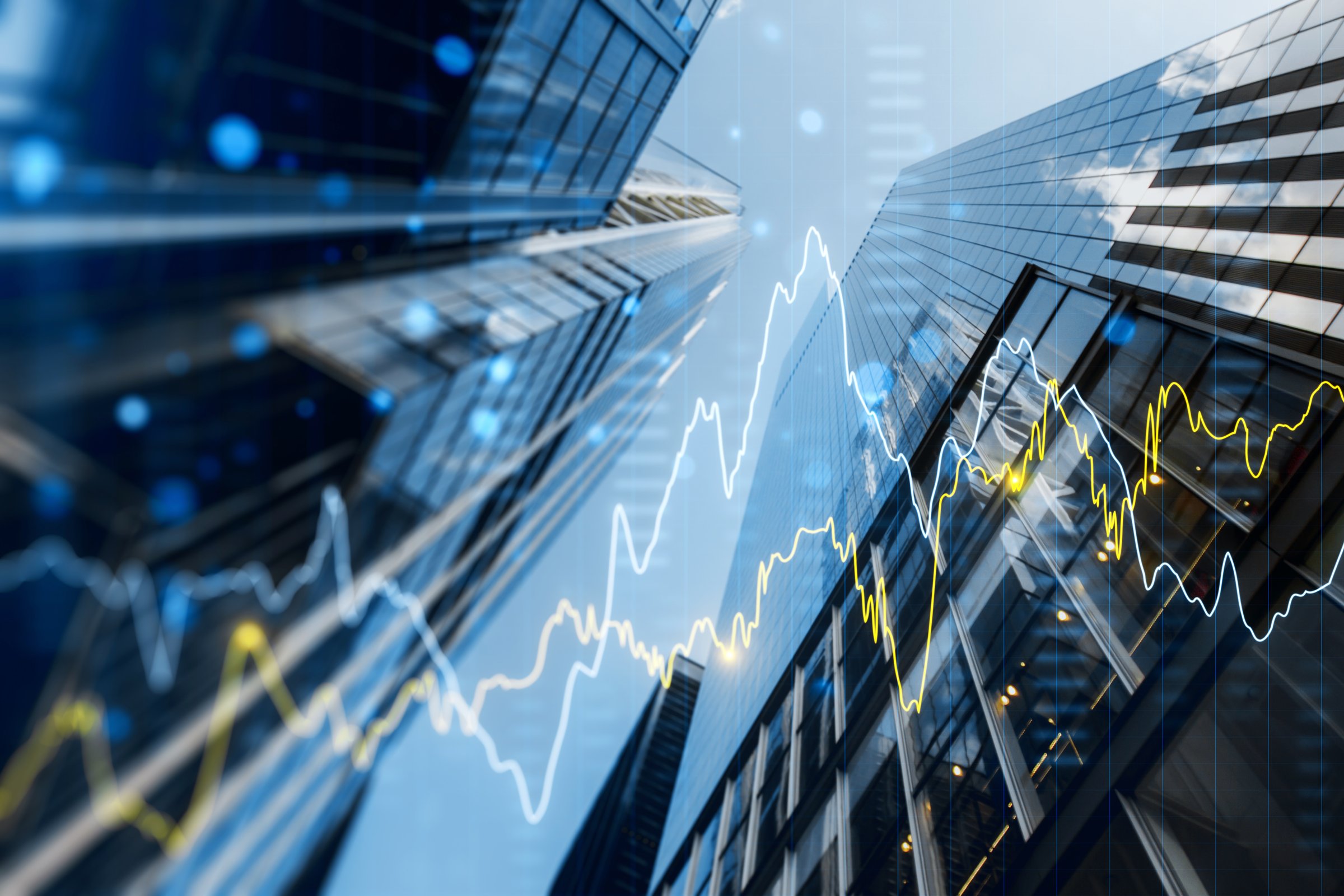 Double exposure of skyscrapers with financial graphs illustrating business growth