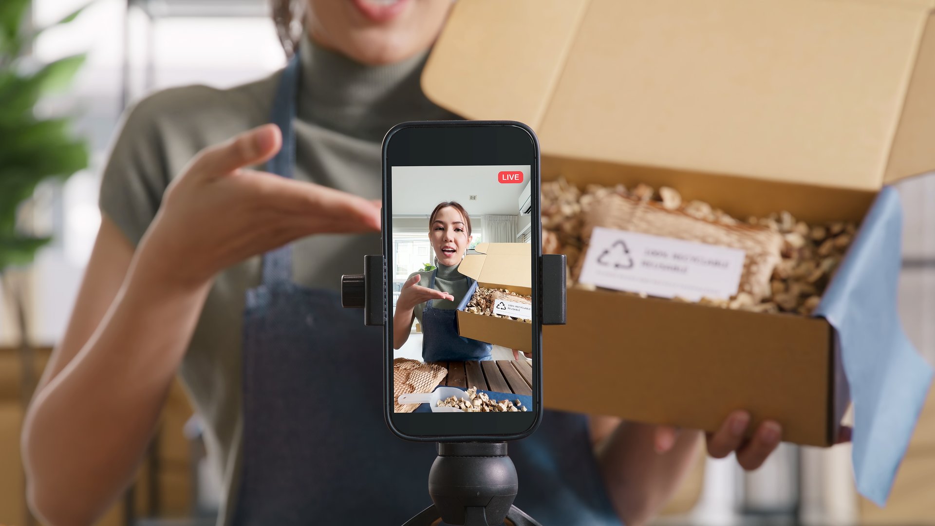 Illustration of a creator filming a vertical video on a phone with TikTok-style icons and subtle brand elements around them