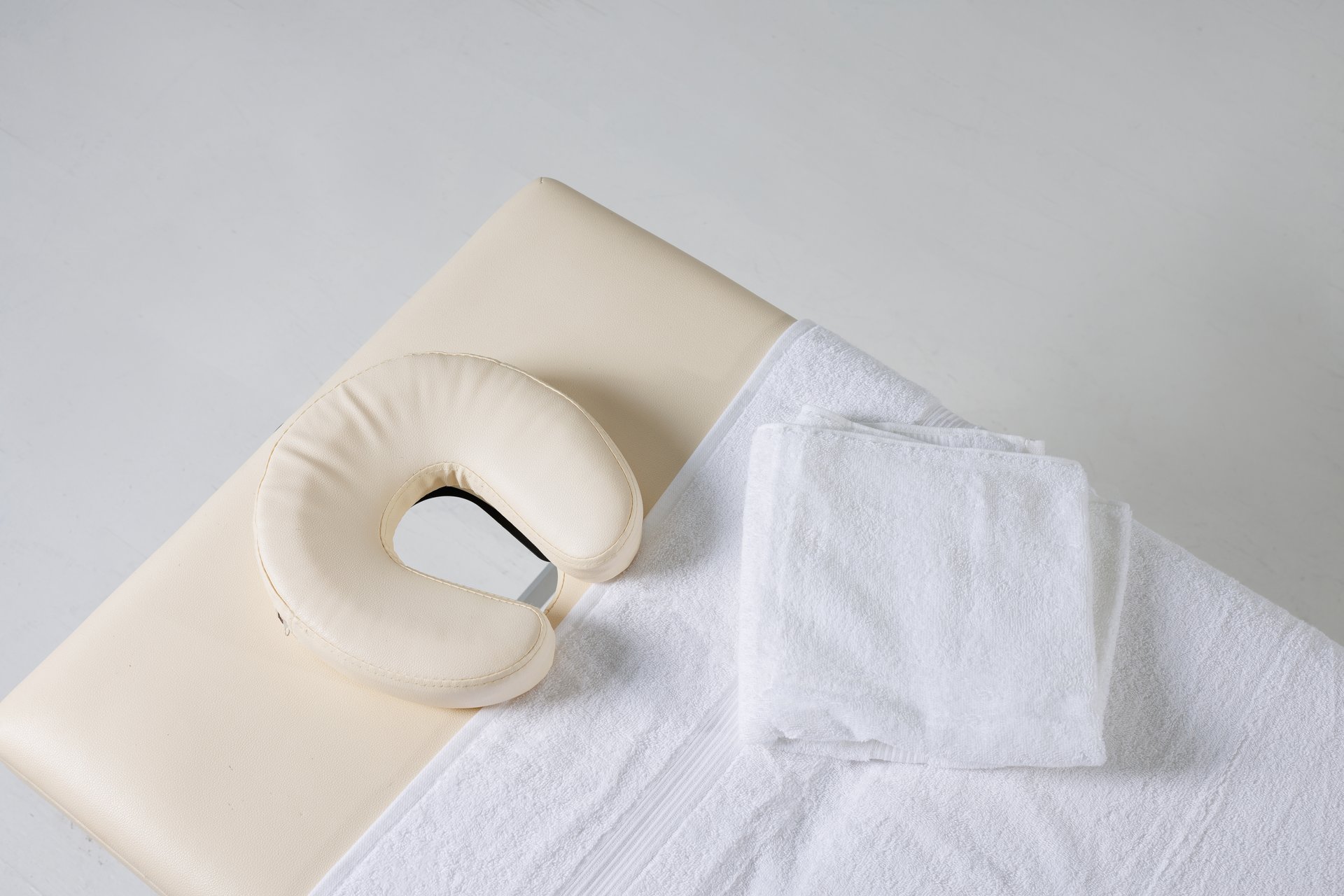 massage table top view on white background, massage therapist workplace, massage concept