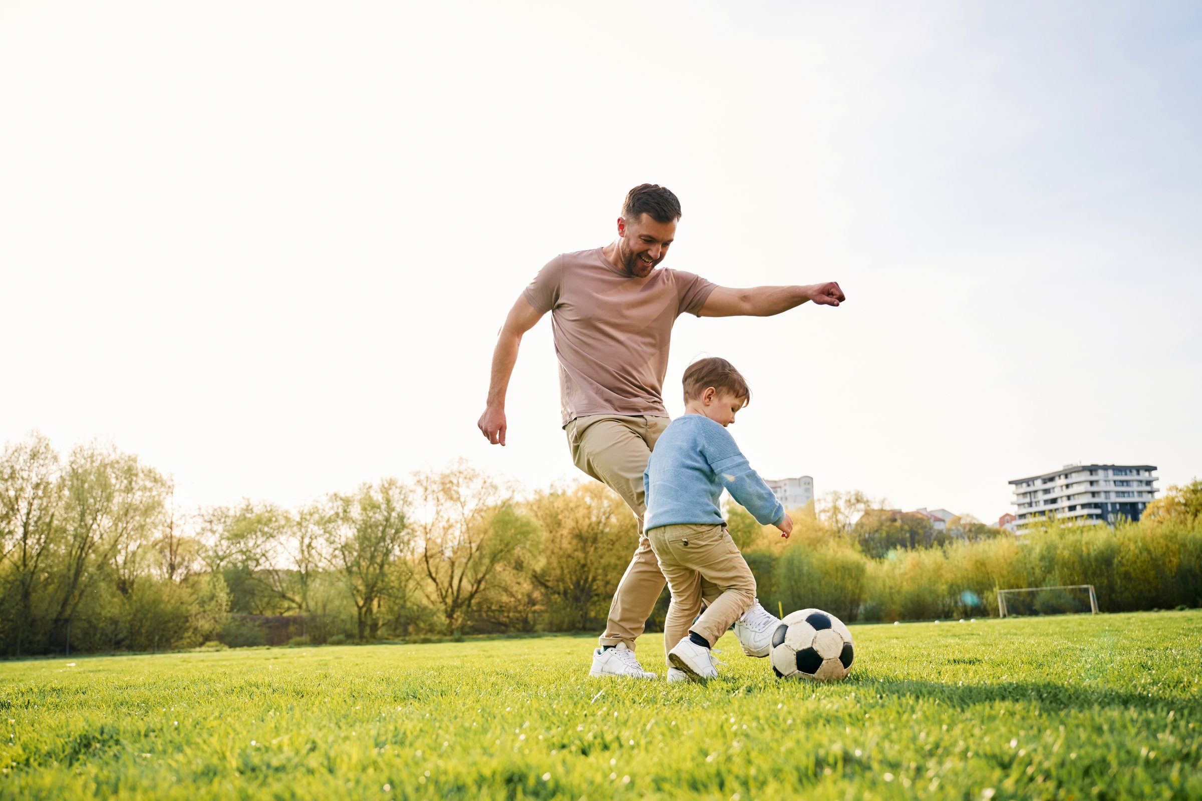Father and son playing soccer