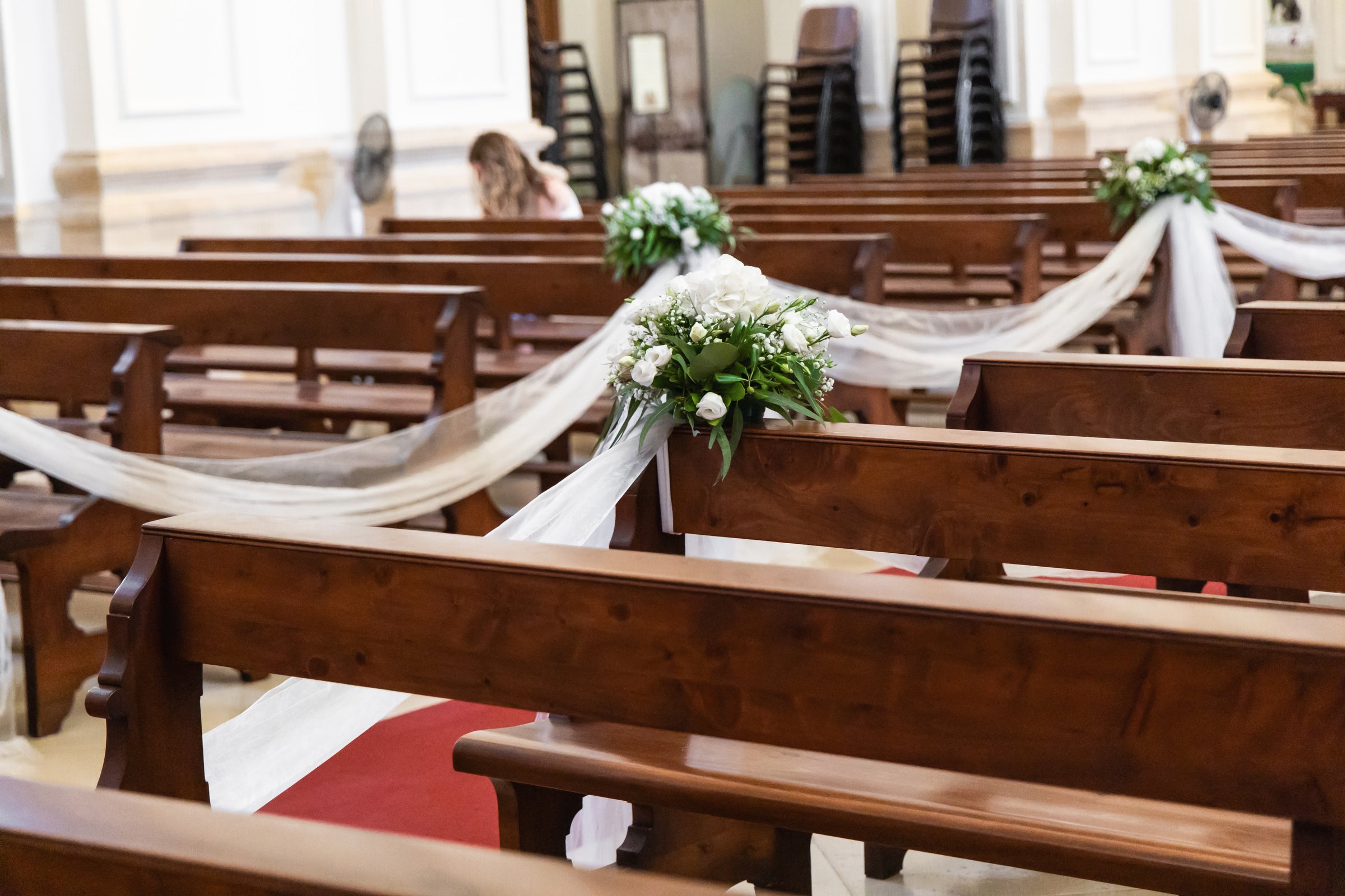 Wedding-ready church with white tulle and flowers