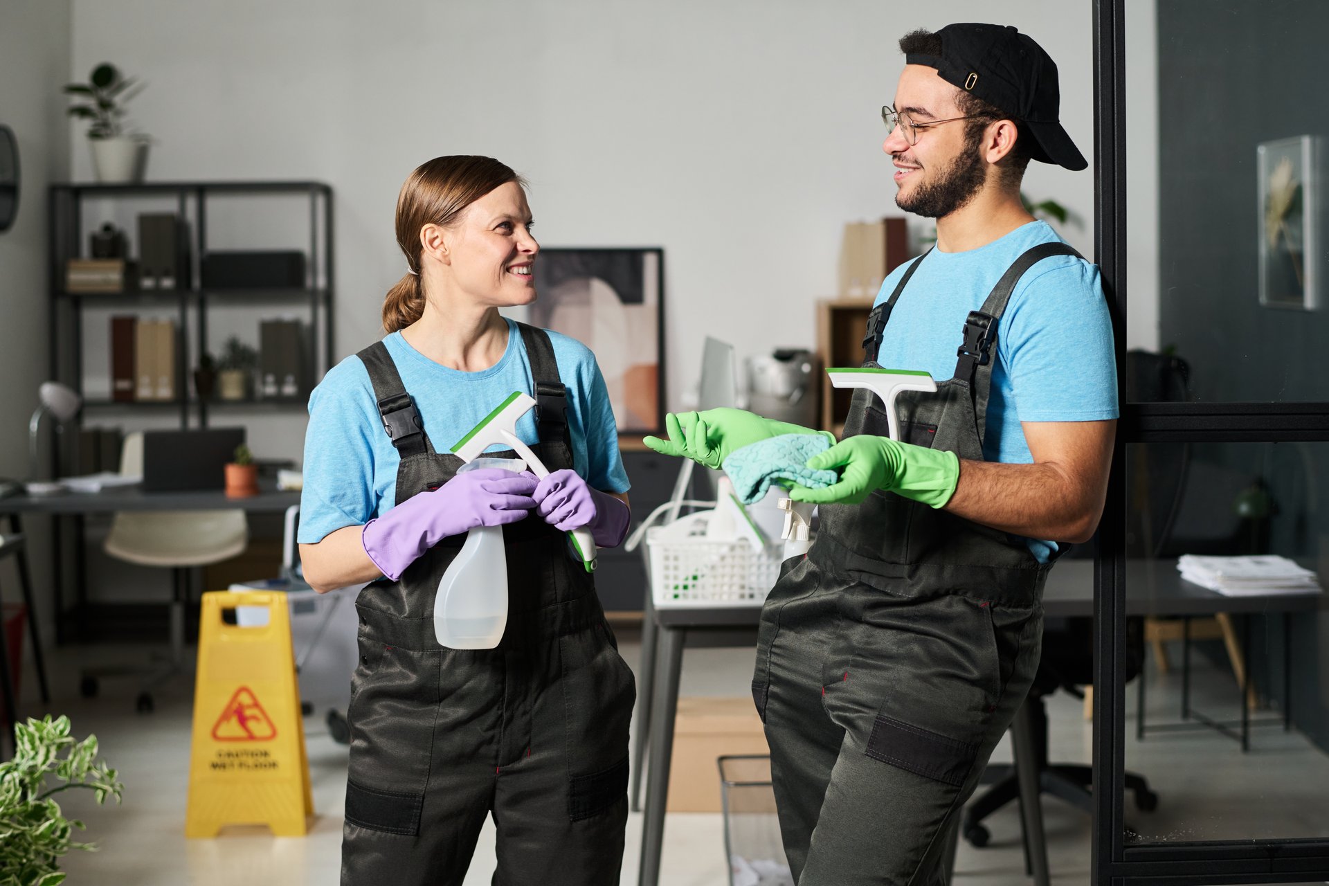 Colleagues in uniform discussing work while standing in office room