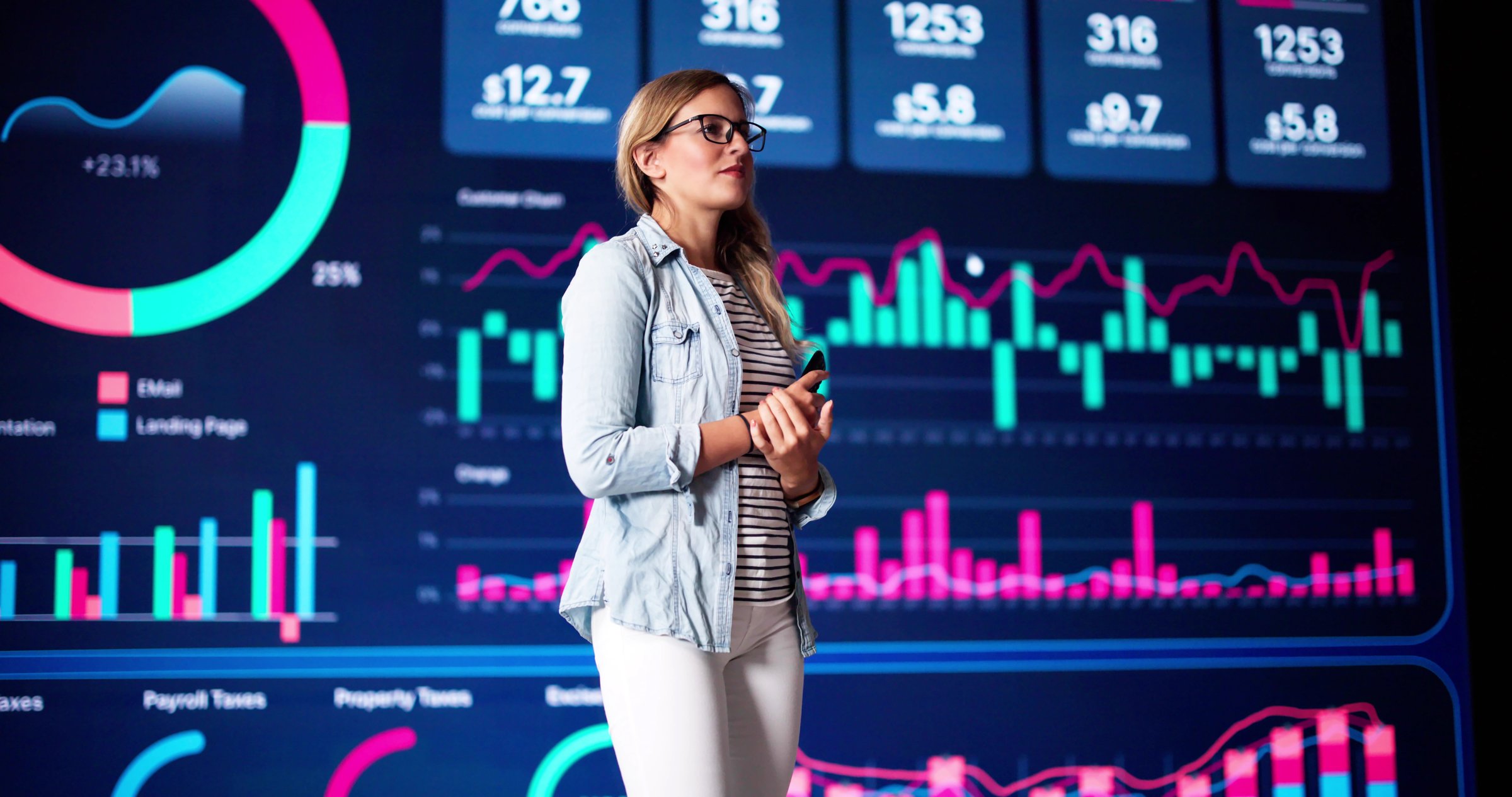 Speaker On Stage At Event Talking To Business Public