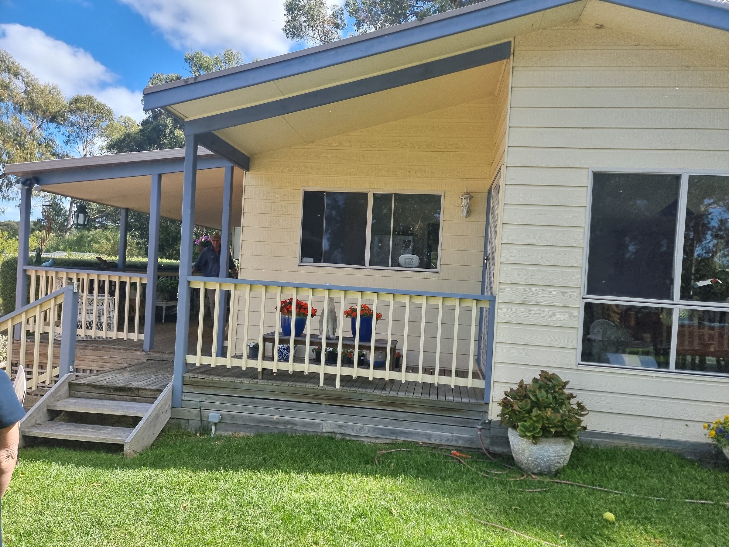 Coastal cottage before painting - weathered exterior condition