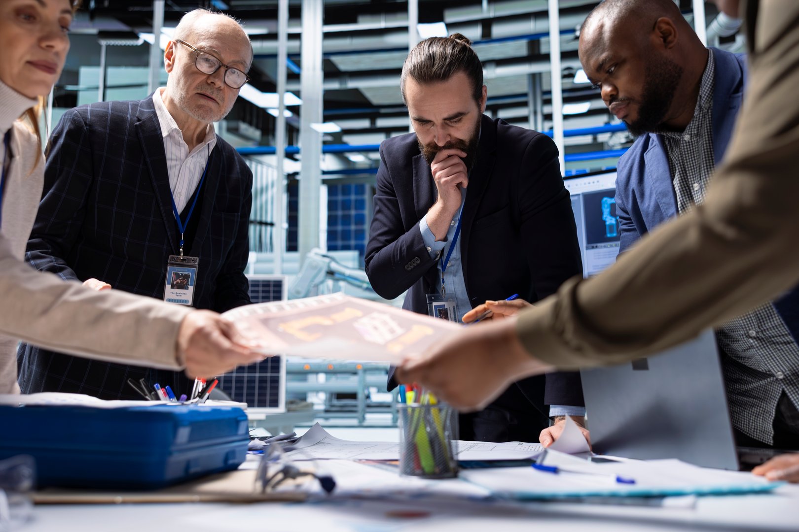 Shareholders meet with production plant managers to talk about manufacturing