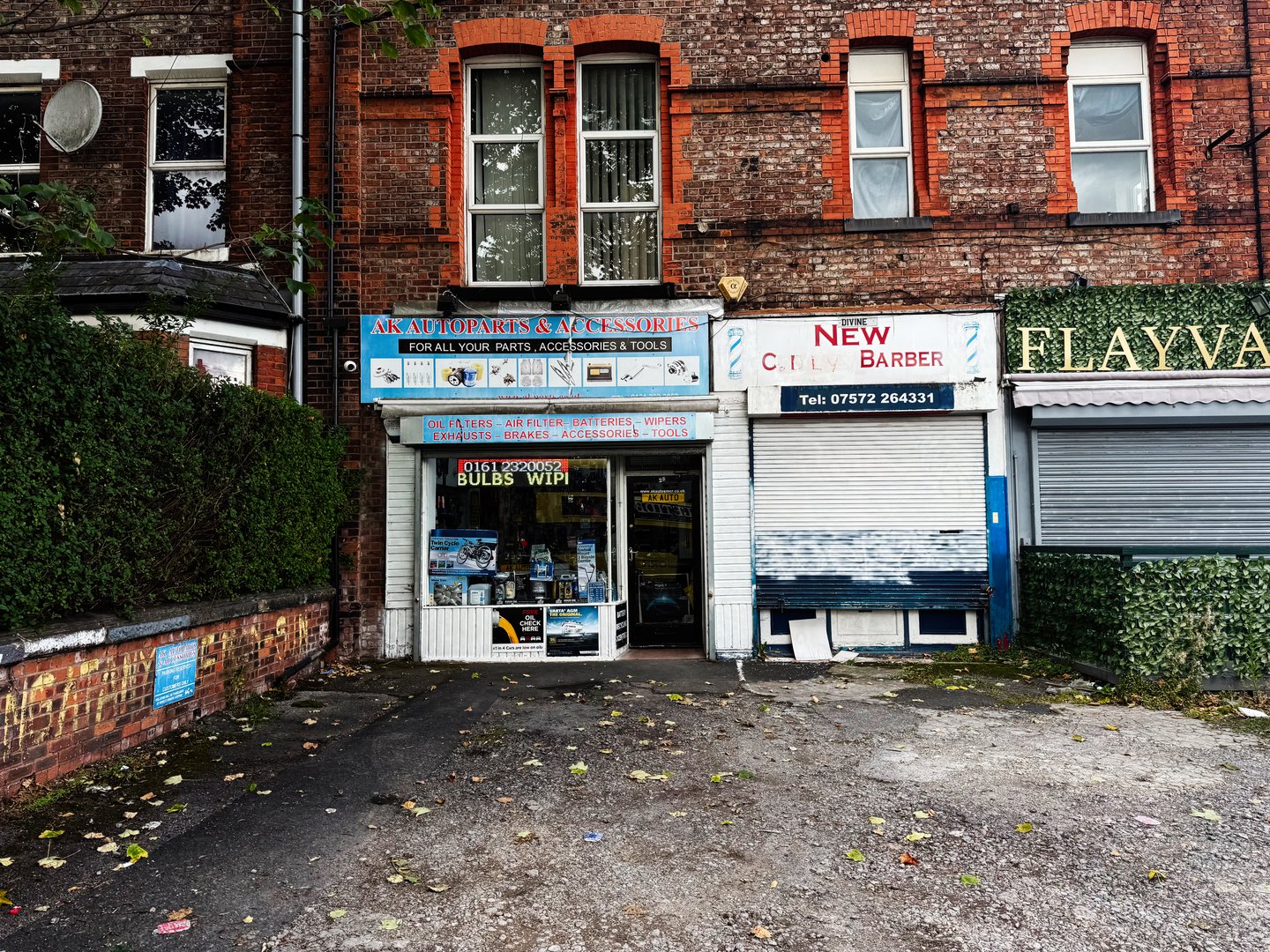 Manchester, UK - September 12, 2025: A view of storefronts featuring brickwork and signs located in Manchester, UK.