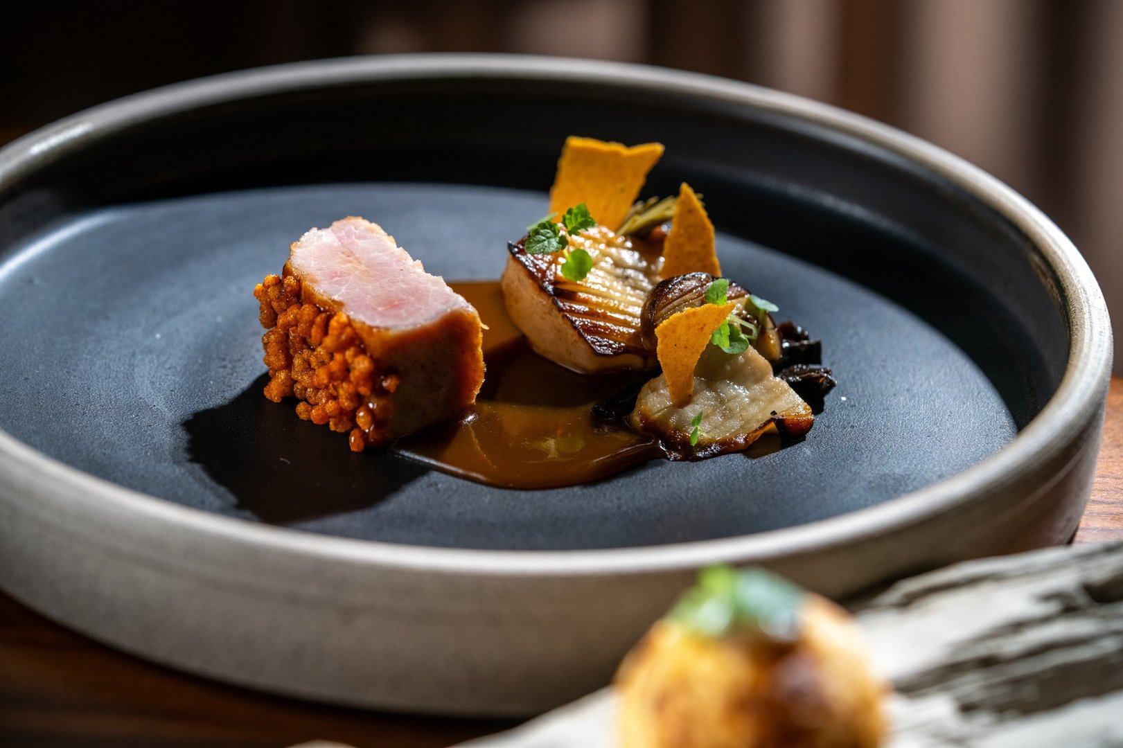 Appetizing gourmet pork meat with crispy texture and sauce on a fine dining plate