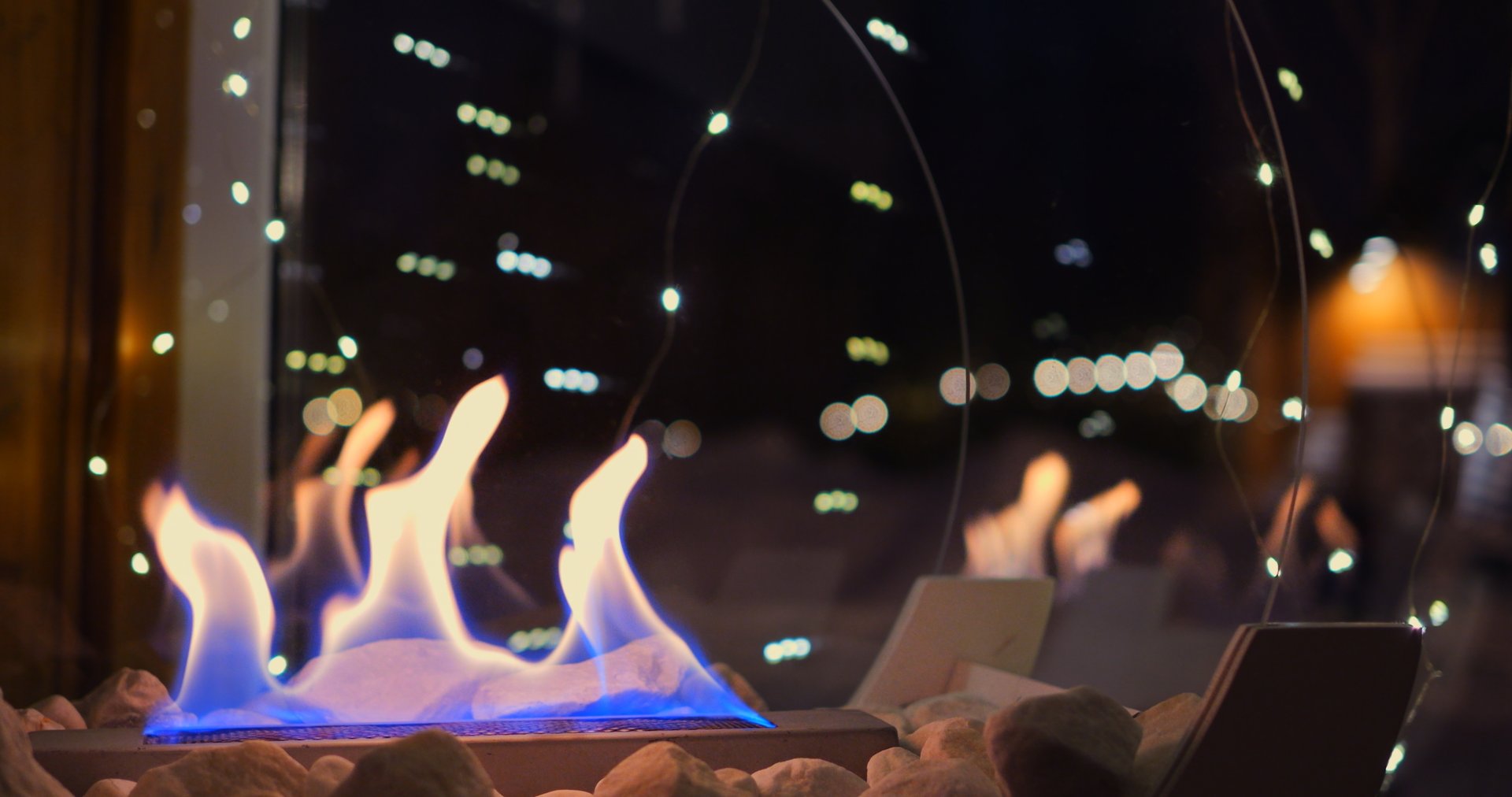 Christmas decorations with biofire create magical holiday atmosphere. warmth of flames paired with twinkling lights brings comfort and joy to winter celebrations. Bio fireplace at christmas.