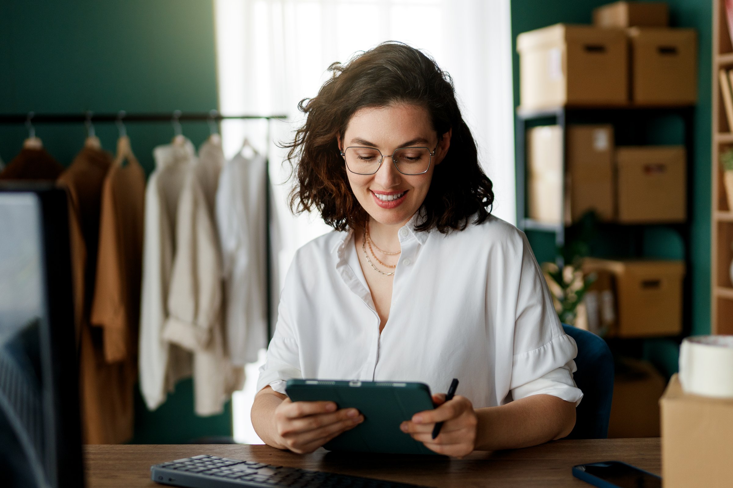 Young woman fashion designer is working in studio.
