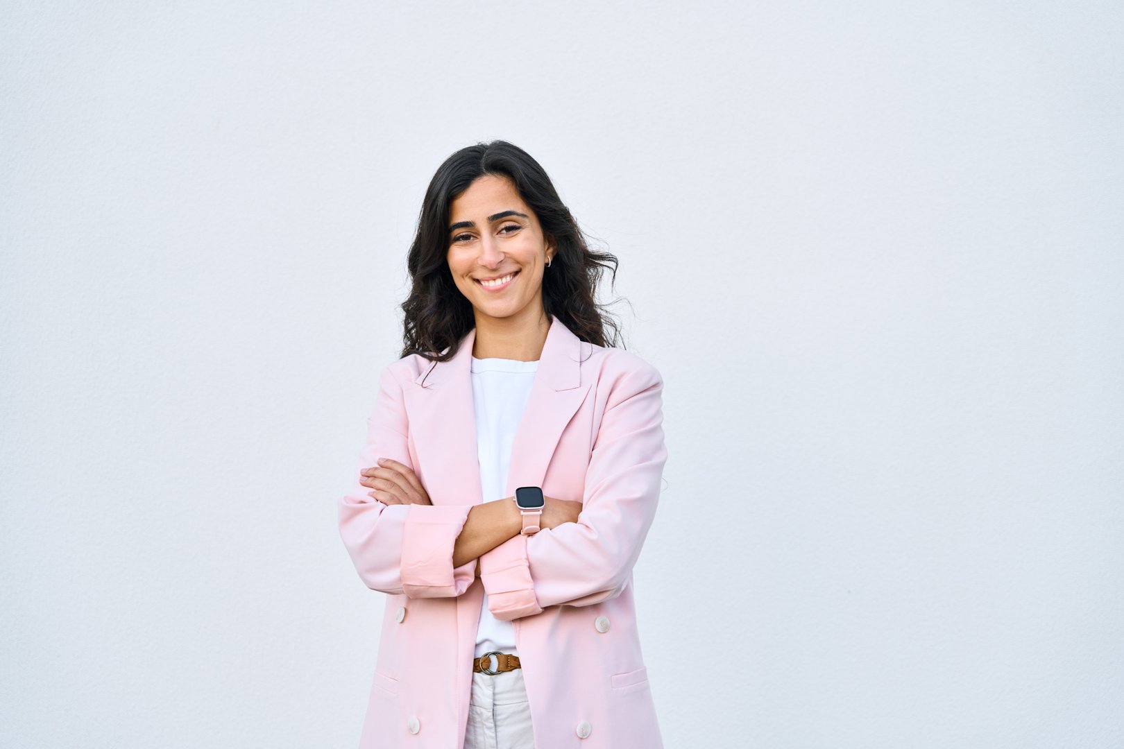 Portrait of middle eastern Israel businesswoman, business lady standing with crossed arms isolated on white background. Smiling young Arabian or Indian woman in suit, looking at camera, copy space