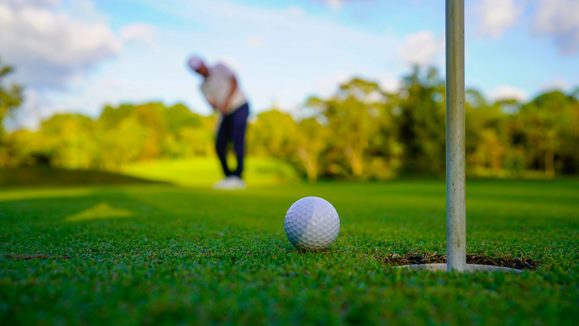 Golfers are putting golf in the evening golf course golf backglound. Golfer hitting golf ball. Sport holiday lifestyle Concept.