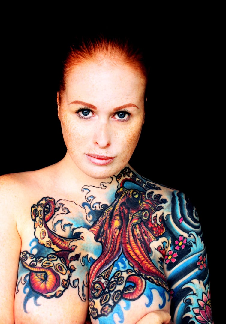 Portrait of a woman with redhead and tattoos