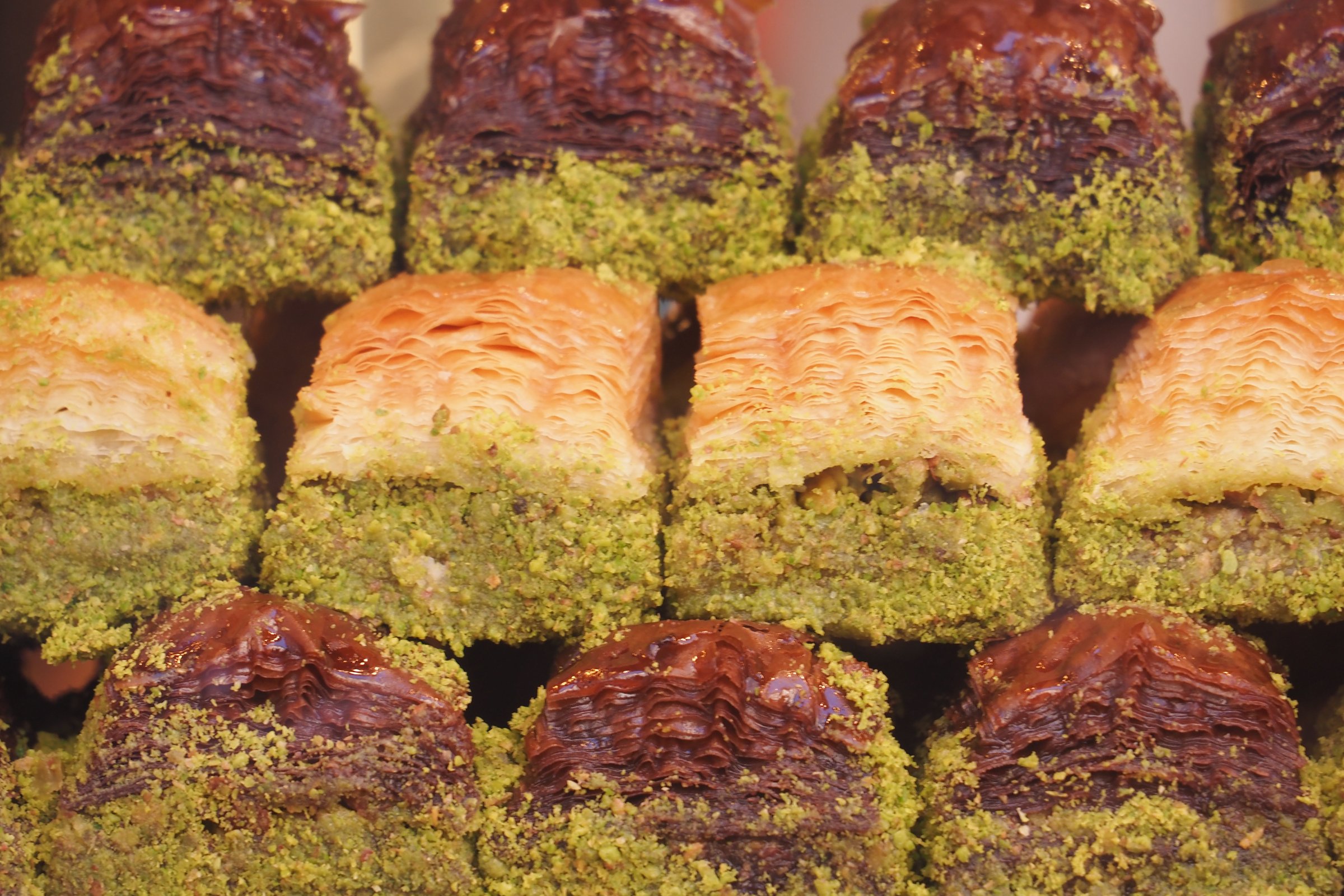 Enjoy authentic baklava slices that are beautifully drizzled with stunning pistachio crumbs
