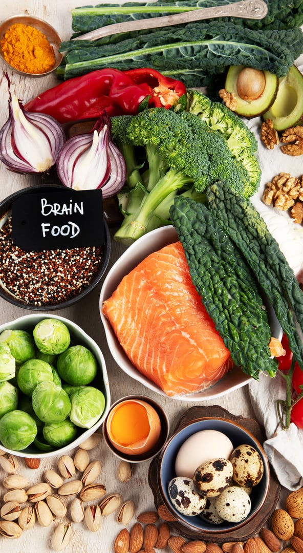 Various brain food products: fish, meat, nuts, vegetables and greens. Healthy food on a light background. Top view.