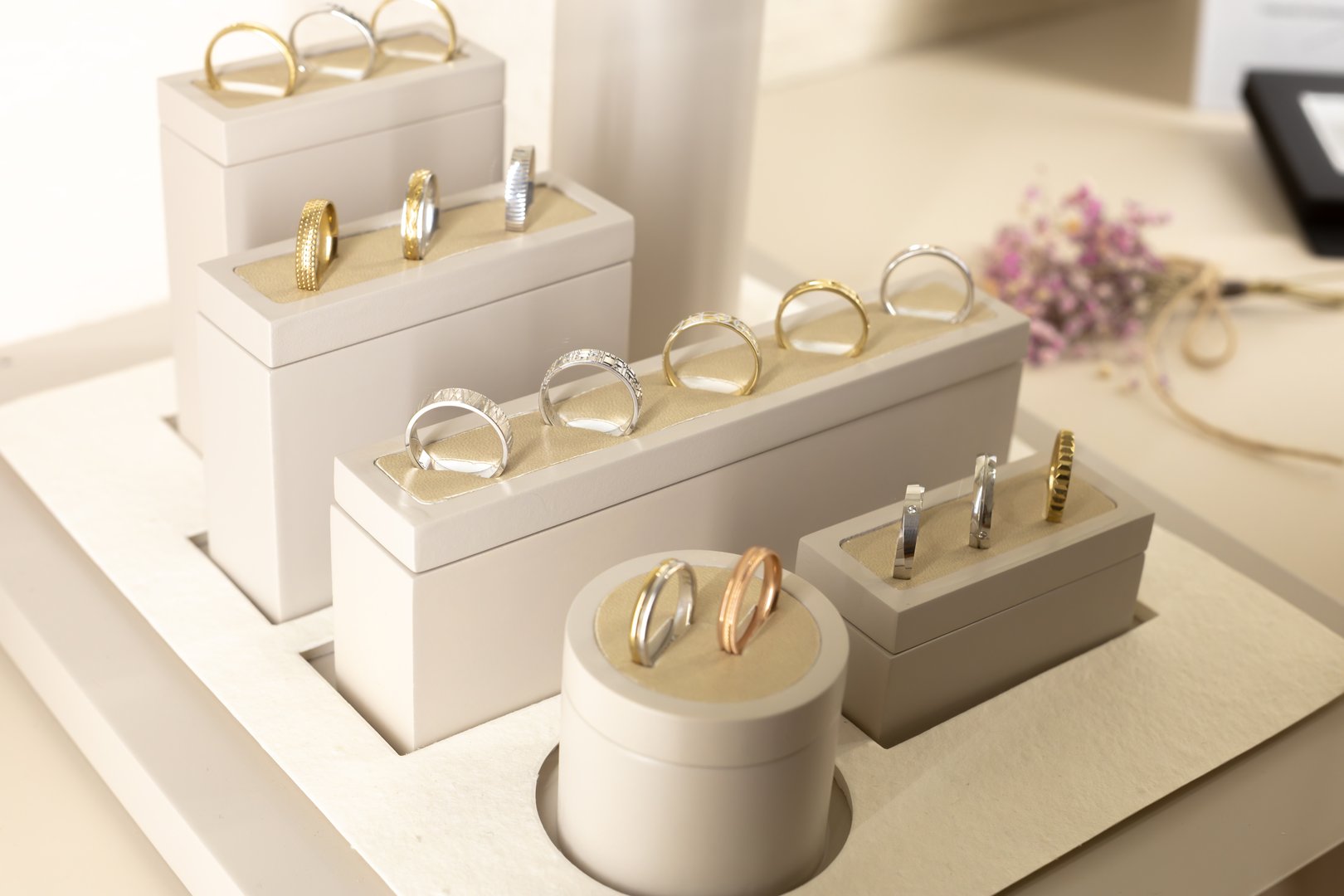 A display of rings in a store. The rings are of different sizes and colors. The display is organized in a way that makes it easy for customers to see and choose the rings they like