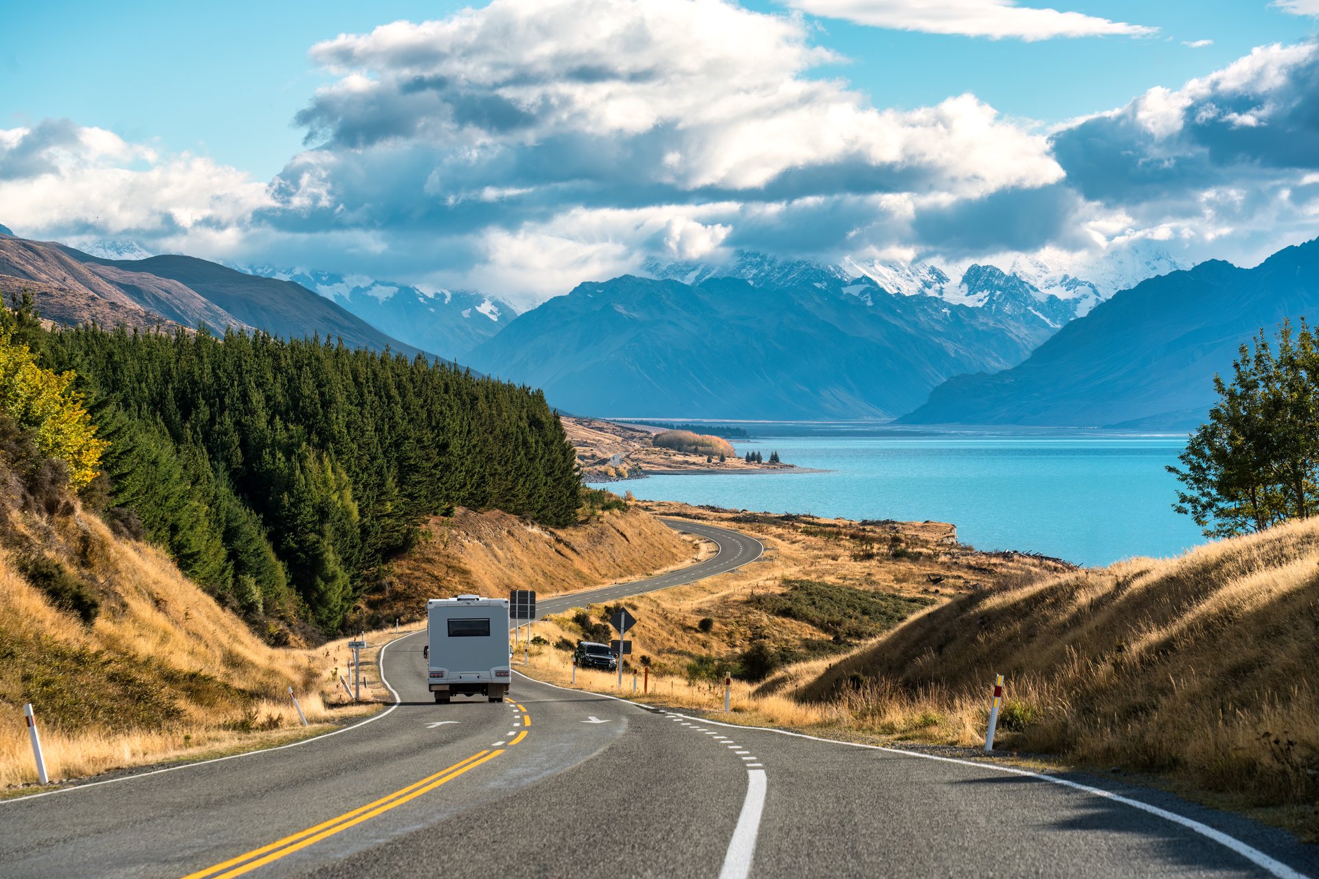 Scenic road trip with mountains and lake, representing the beautiful landscapes you'll encounter in Chile