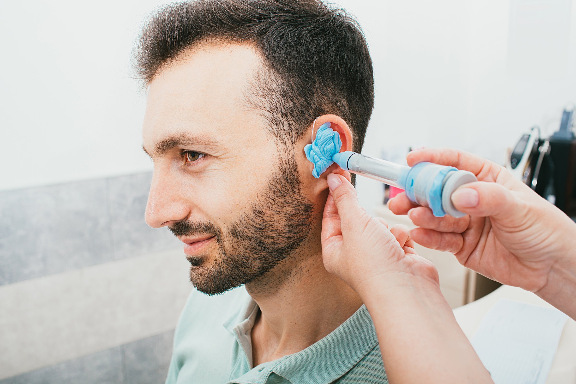 process of molded individual hearing aid earmolds. A man, having procedure making individual earmolds