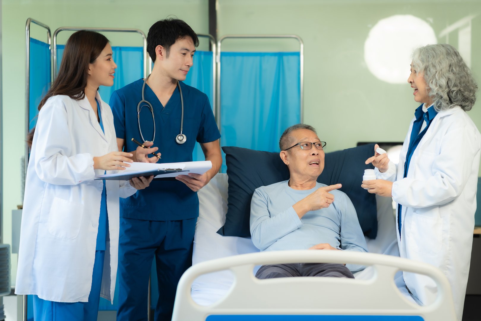 medicine, healthcare and people concept - doctor talking to male patient at bed in hospital.