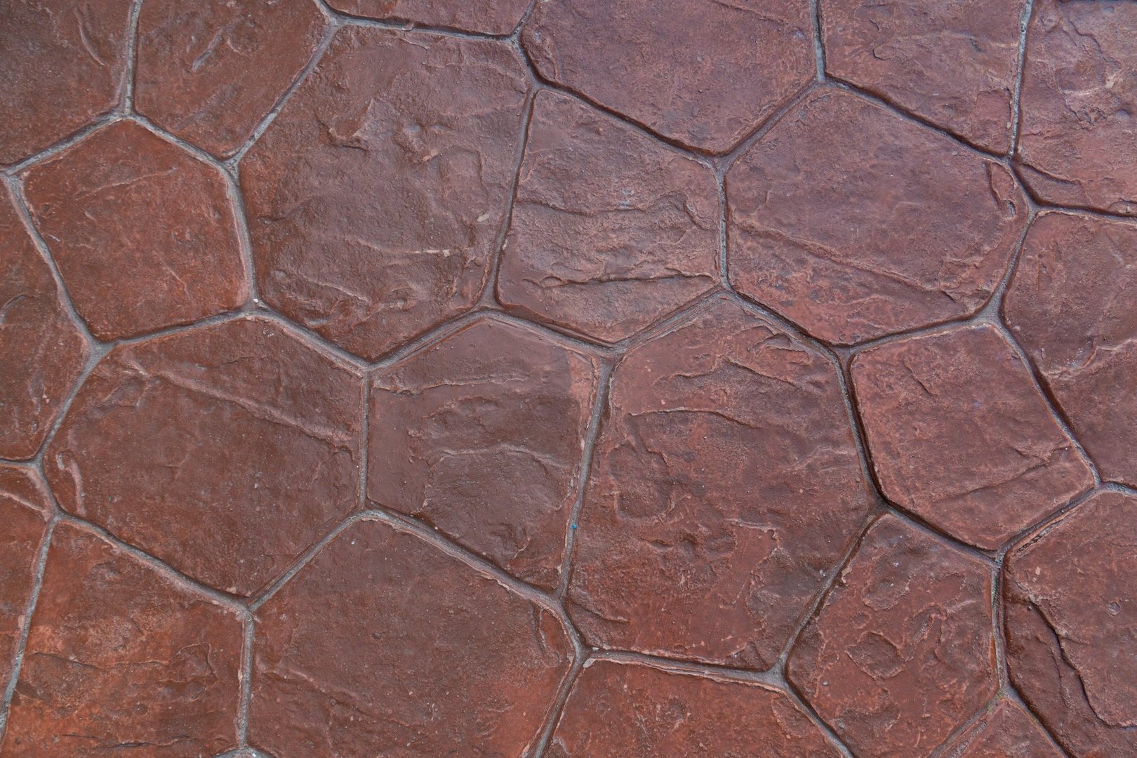 Cement floor is decorated with a stone crevice pattern painted in orange. For background and textured.