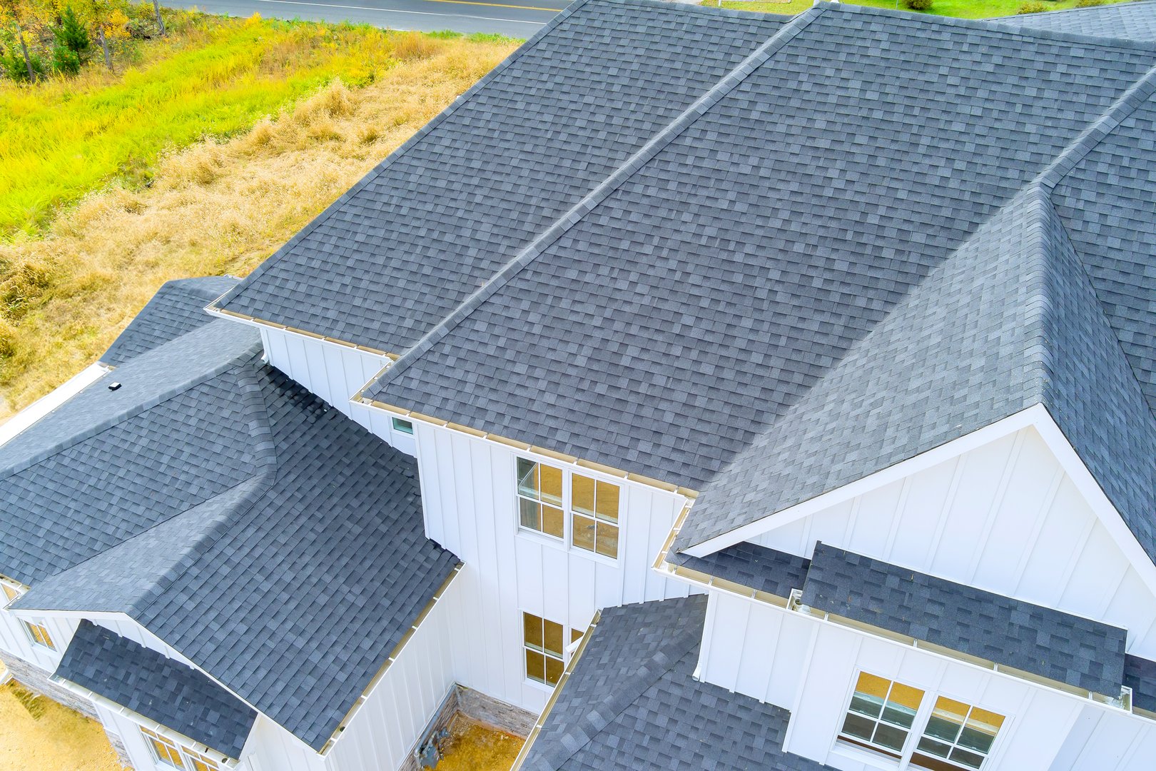 Roof of newly constructed house is covered with asphalt shingles