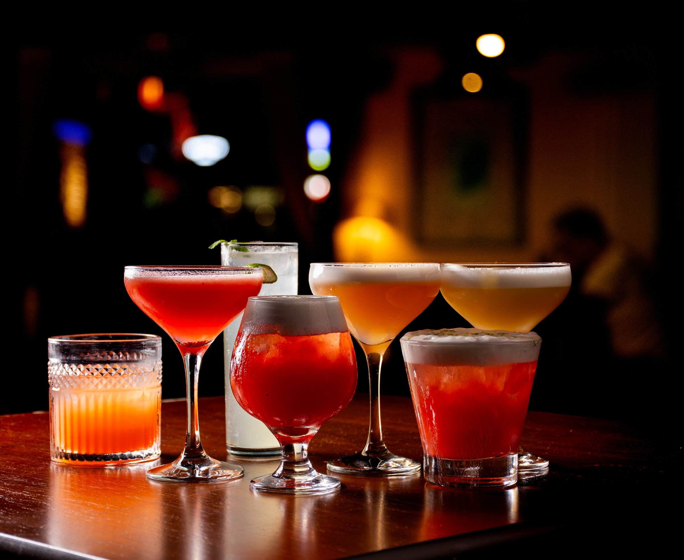 collection of colorful cocktails and drinks with pub on warm light blur background