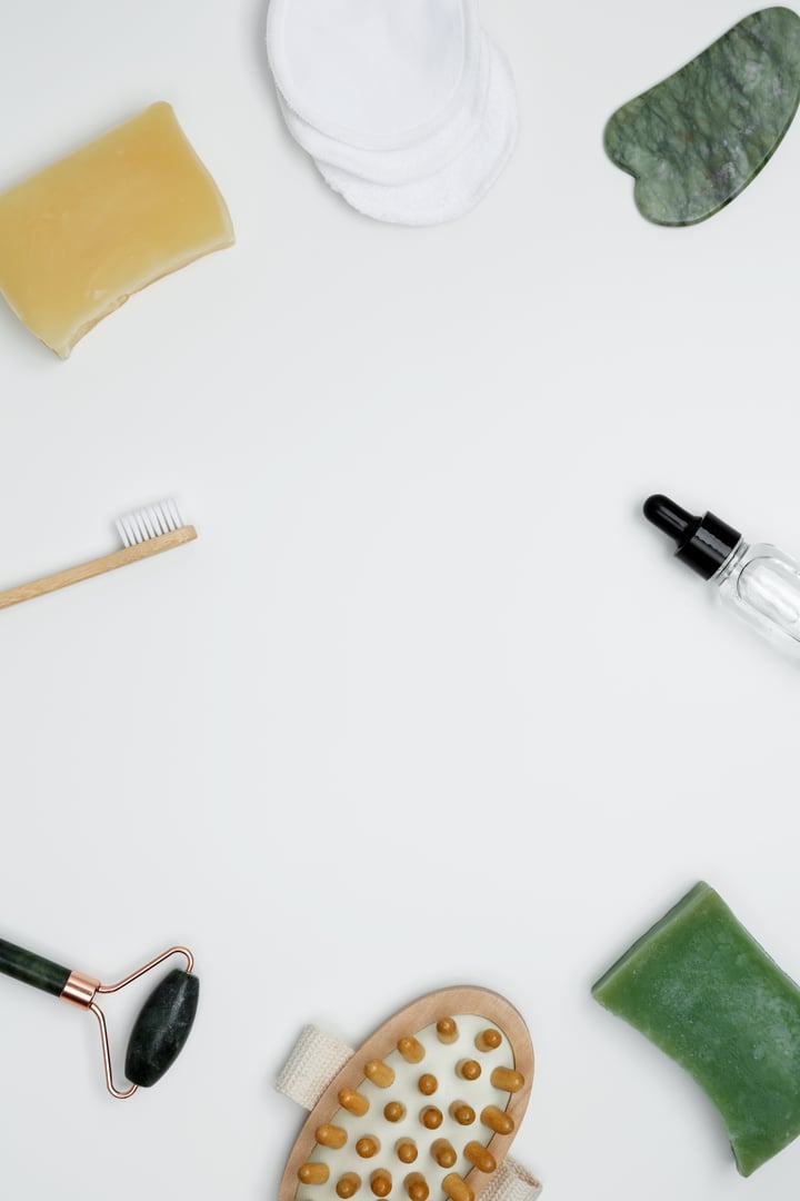Embodying a sustainable self-care concept. Eco-friendly beauty essentials, including soap, bamboo toothbrush, marble face roller