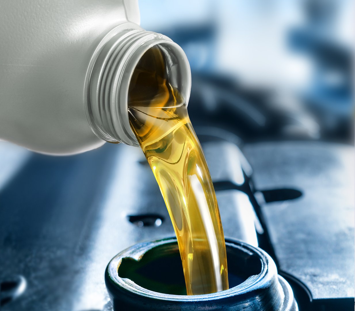 Motor oil being poured in car engine