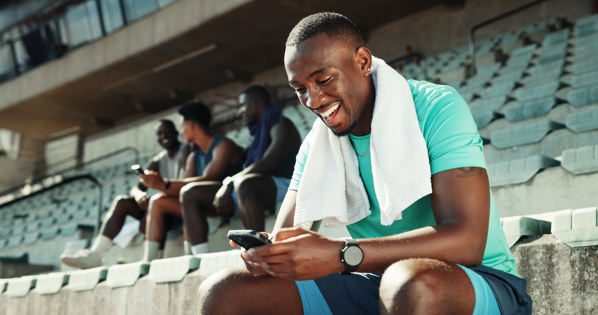 Stadium, man and laughing with smartphone for fitness, online communication and meme on application. Outdoor, male person and typing with mobile for funny chat, social media and break for exercise