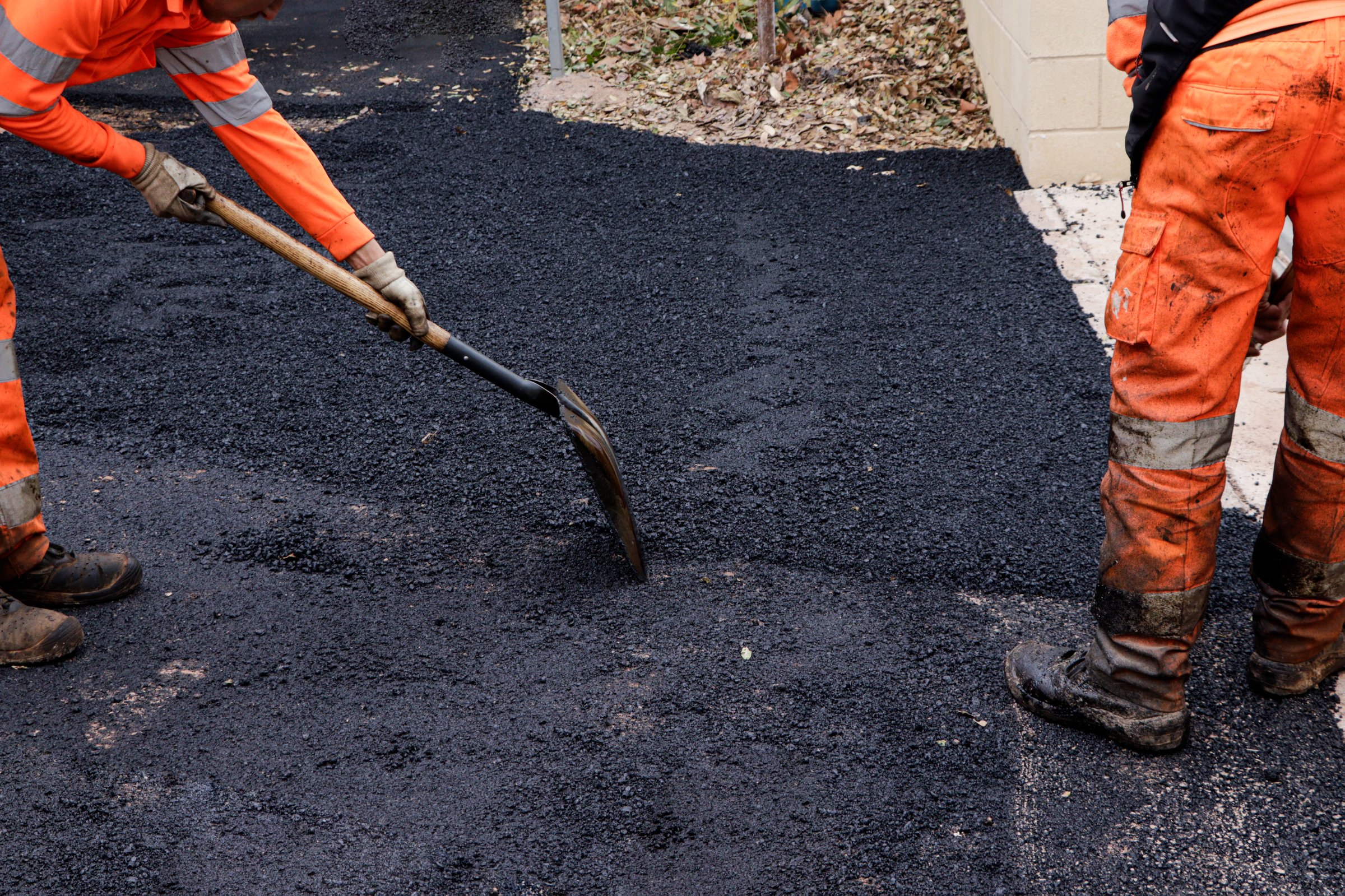 workers repairing holes in the street