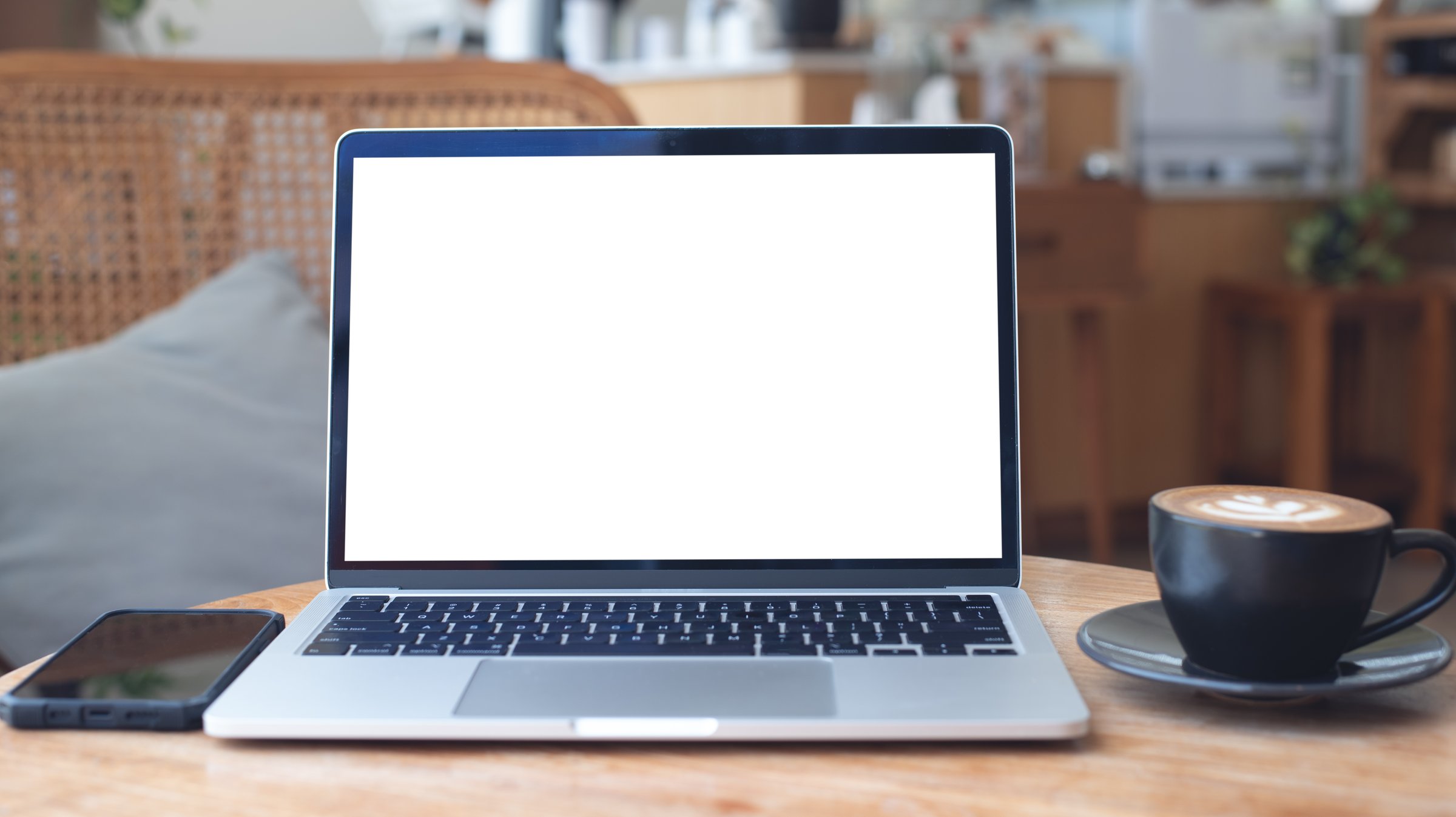 Mockup, laptop blank screen on wood table with coffee cafe background, template for your text advertisement, front view