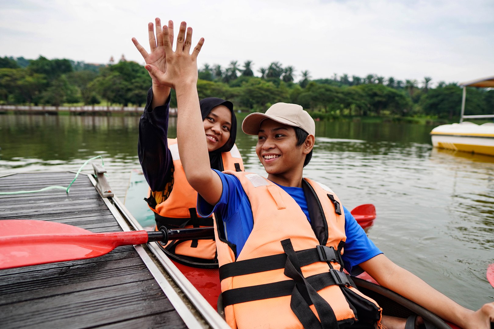 Happy Boy with Family Kayak Outdoor Lake