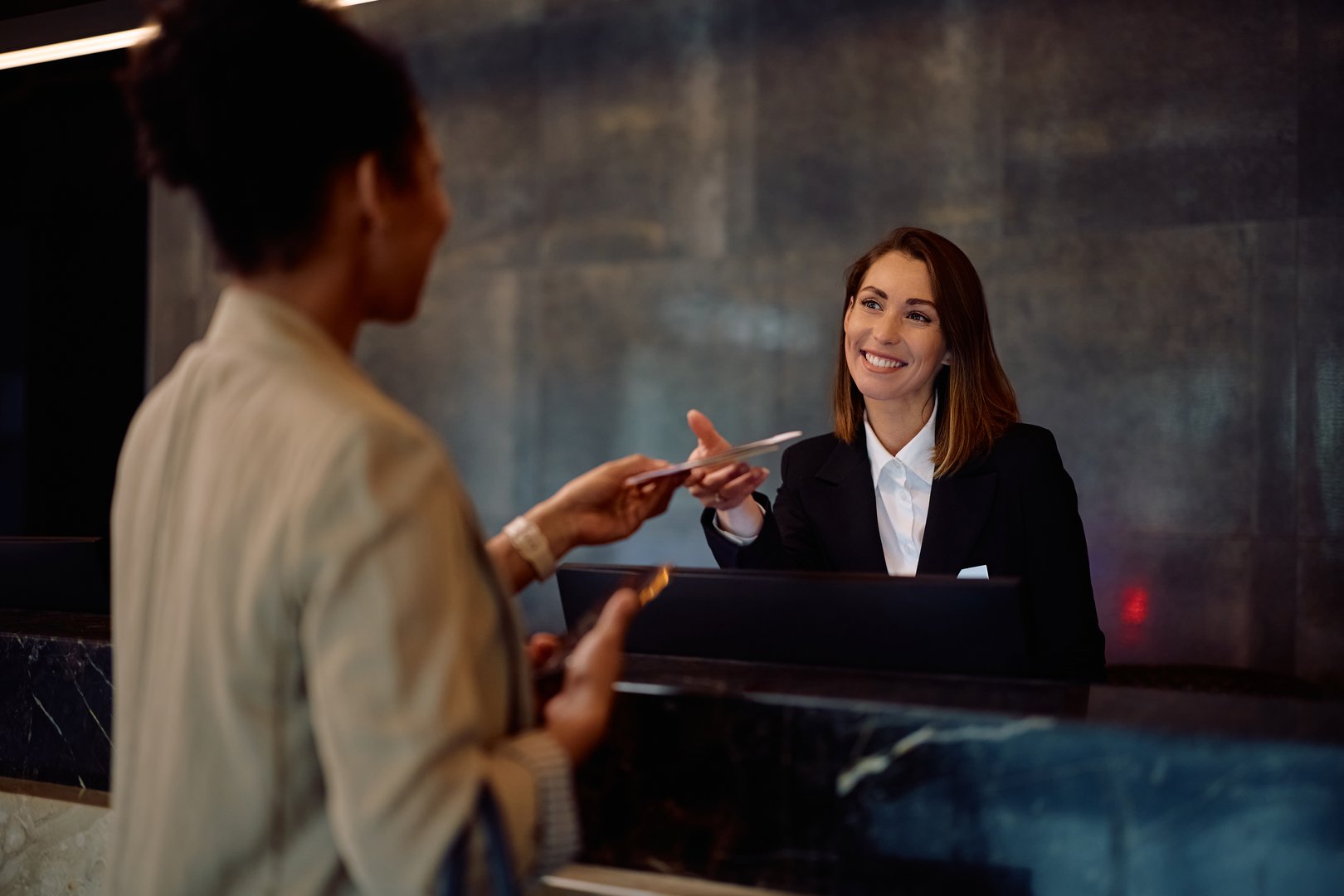 Female receptionist at hotel front desk