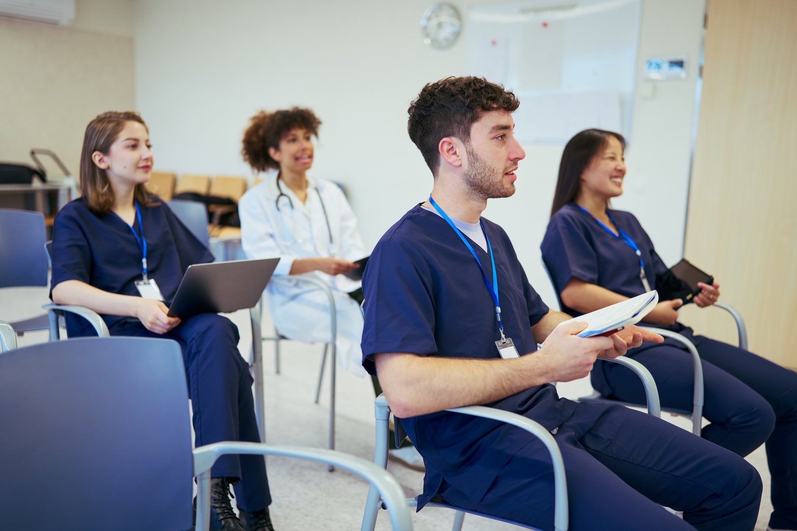 Doctors and nurses listening attentively at a medical conference, showcasing teamwork and collaboration in healthcare