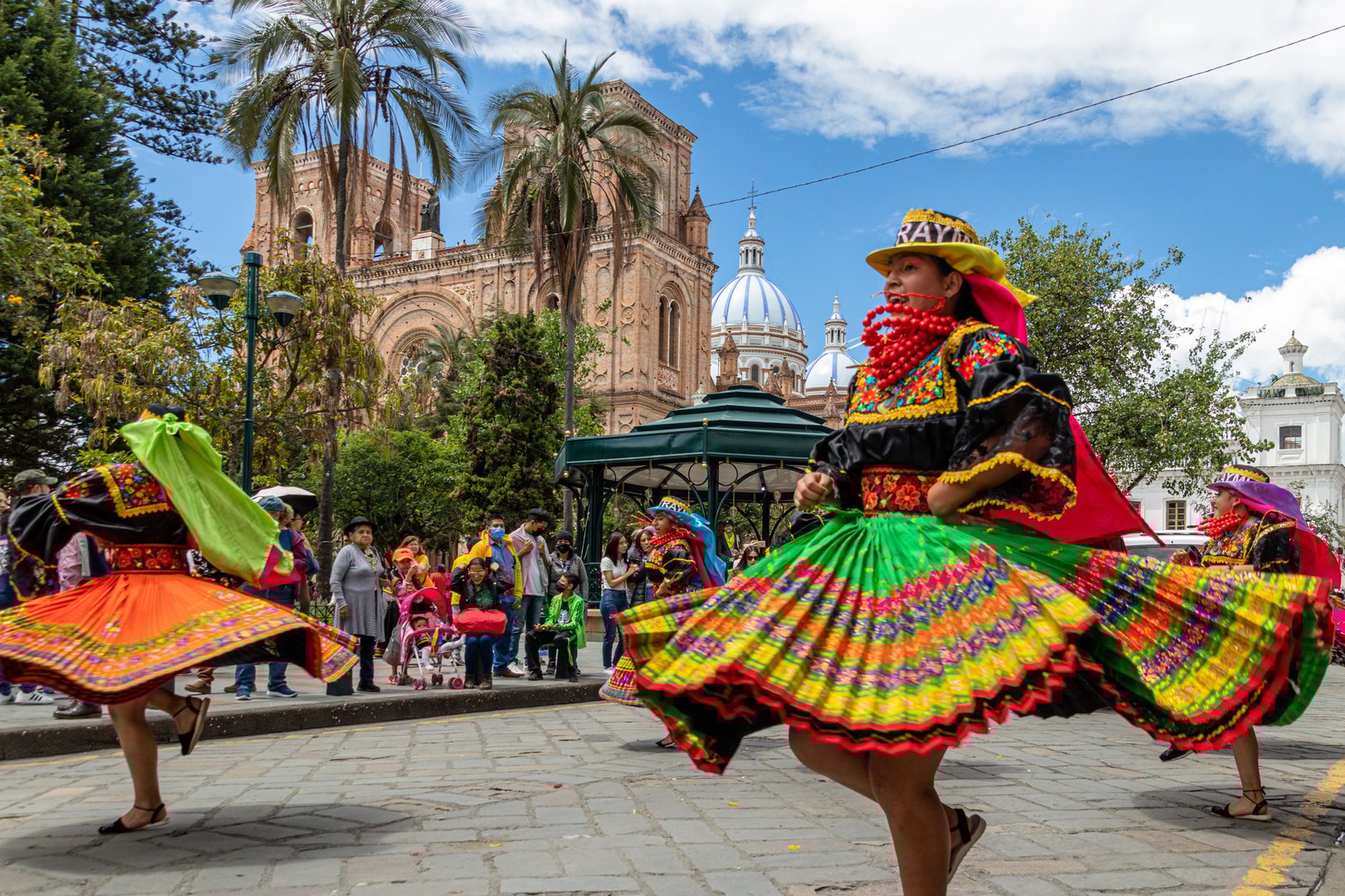 Cuenca, Ecuador - January 14, 2023: Pase del Niño Viajero celebration. A group of folk dancers from Cayambe Canton, Pichincha Province in colorful traditional dress in historical center of Cuenca