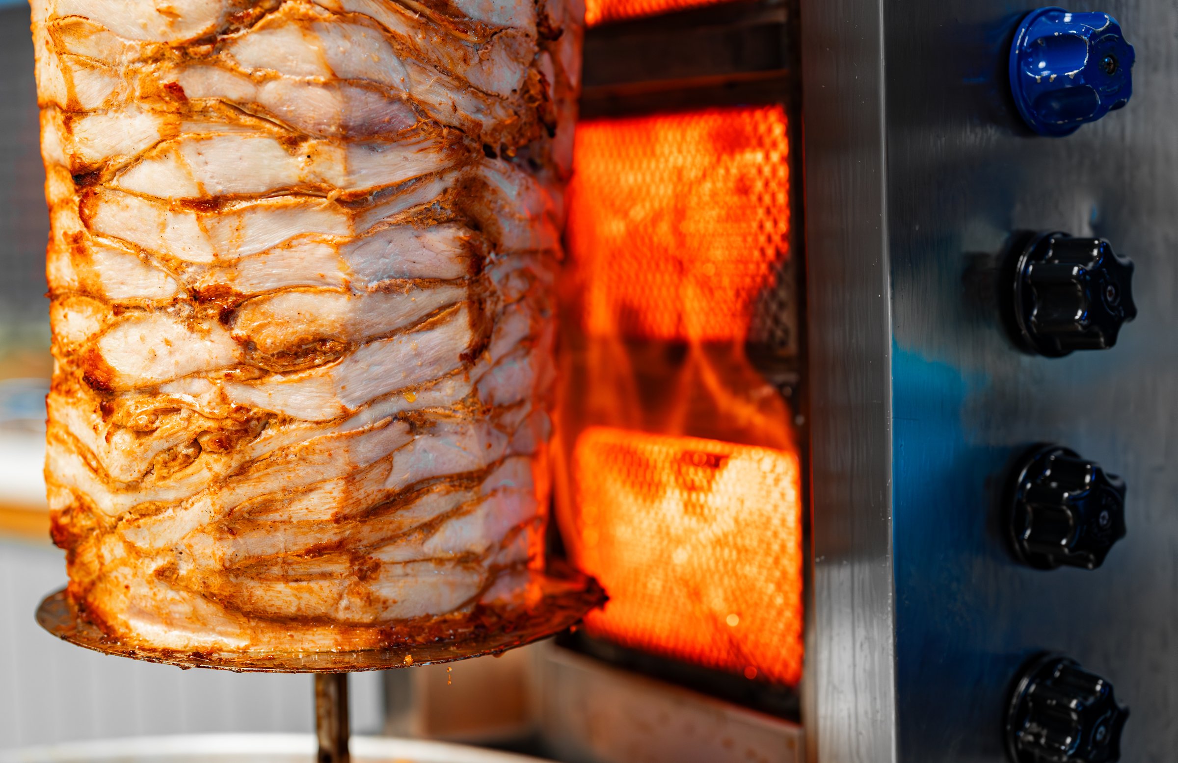 Juicy meat is fried on a shawarma spit.