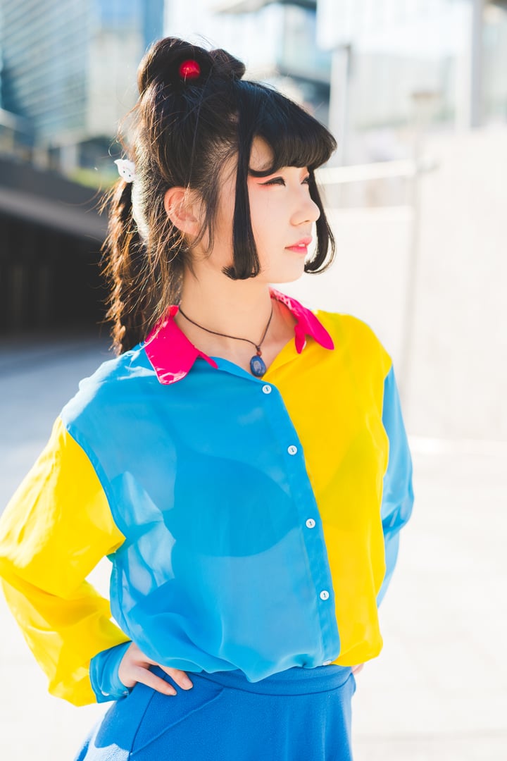 Young beautiful nonconformist asiatic woman posing outdoor in the city overlooking - eccentric, stylish, hairstyle concept