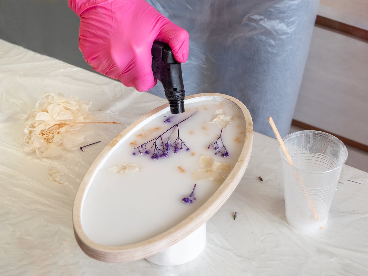 Artist working with epoxy resin in studio