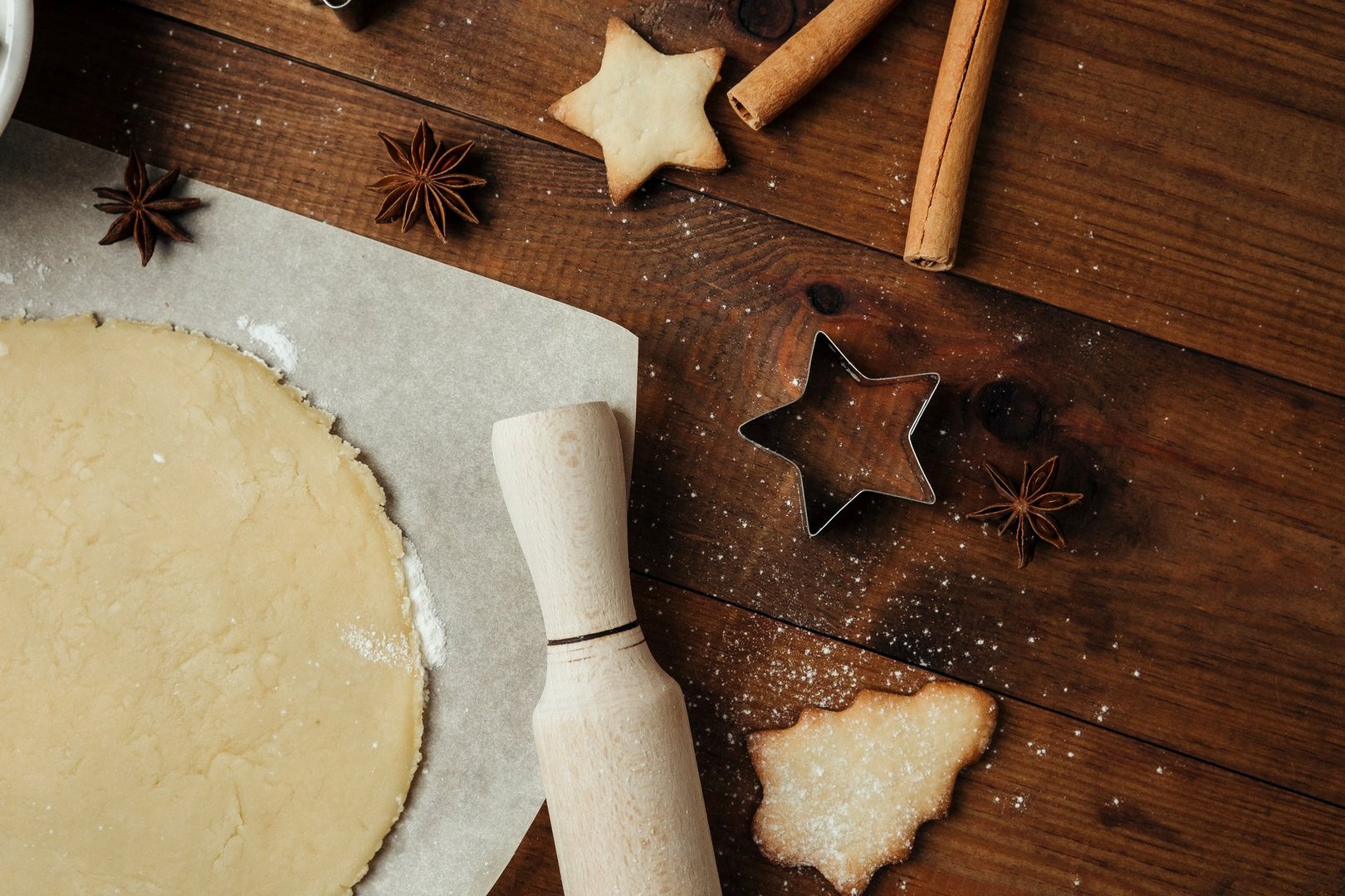 Festive cookie dough and baking setup on wooden table for christmas culinary and rustic food concept