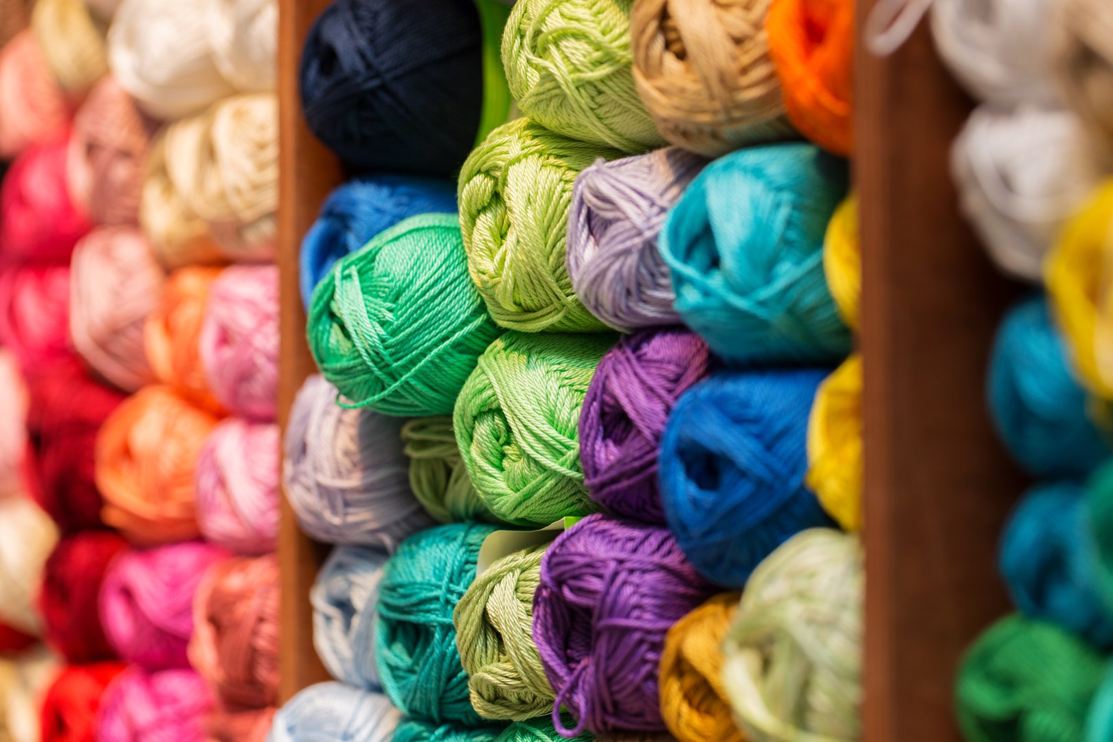 shelves with colorful wool and yarn in a knitting shop