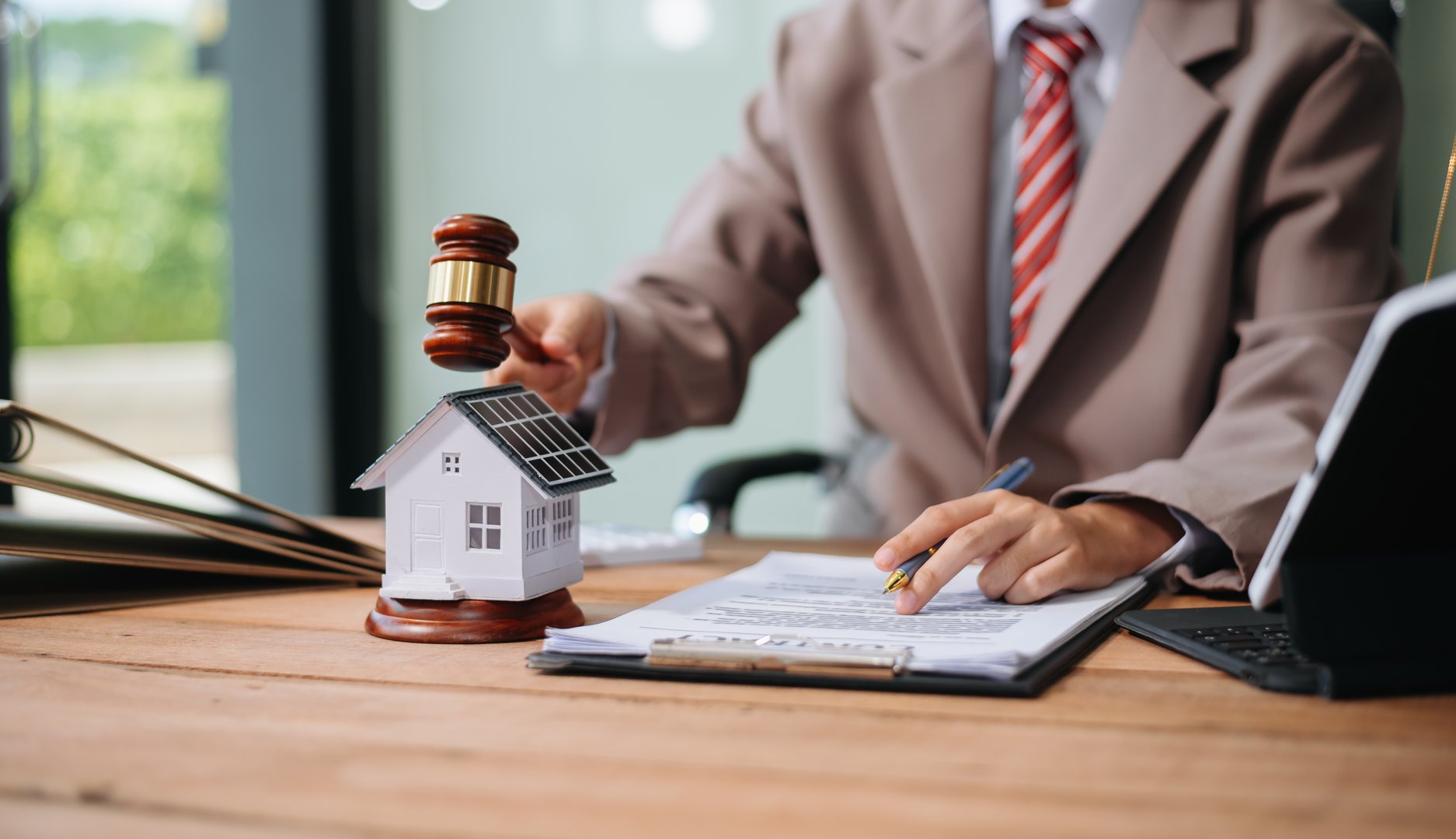 Real Estate Lawyer And House Foreclosure Law. House model, hammer judge gavel on table with white background. Foreclosure, bankruptcy concept Person is unable