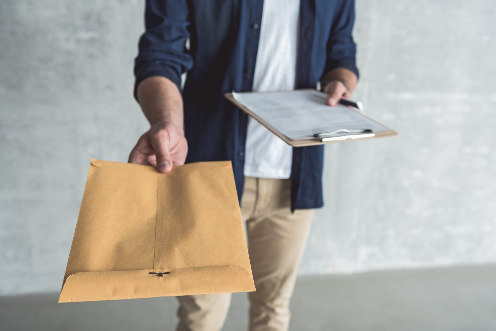 Professional courier carefully handling confidential documents and contracts